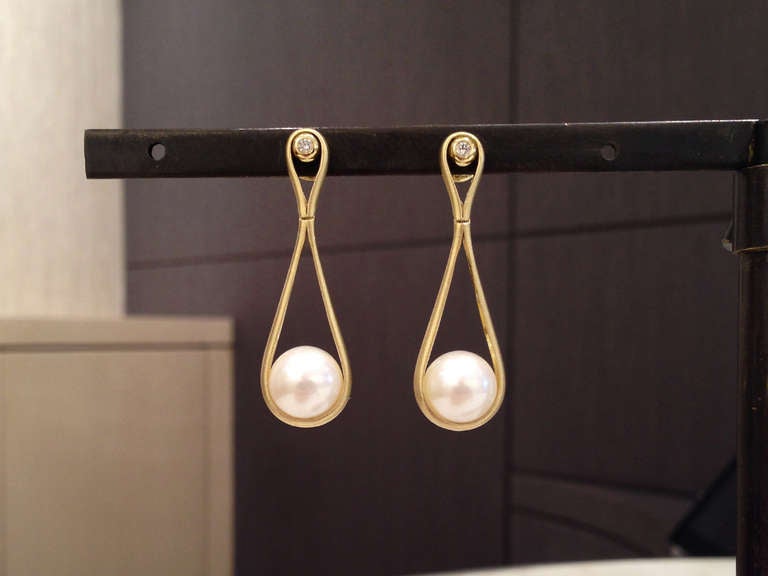 Hand-Crafted Swing Earrings in 18k yellow gold with pearl drops and diamond accents. The Drop sways elegantly with the wearer.