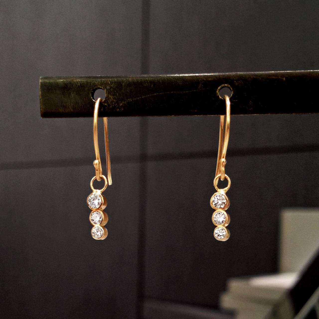 Dangle Earrings handcrafted in 14k yellow gold with six round, brilliant-cut white diamonds descending in size. Incredible sparkle!