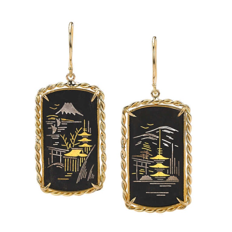Stunning, one-of-a-kind Demascene Shakudo Earrings. While the designer, Russell Trusso, has added the 18k yellow gold setting and wires to the pair, the piece has retained all of its original qualities including the spectacular gold-plated sterling