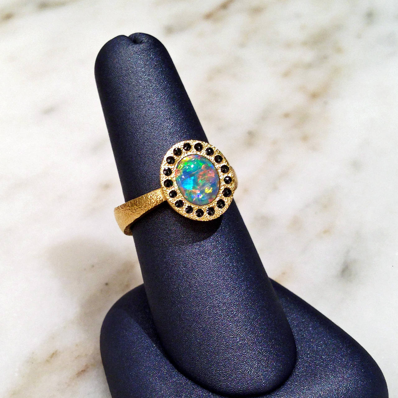 Ring handcrafted in 22k yellow gold with a spectacular Lighting Ridge opal crystal showcasing rare red flash and surrounded by rose-cut black diamonds. Size 8 (Can be Sized).