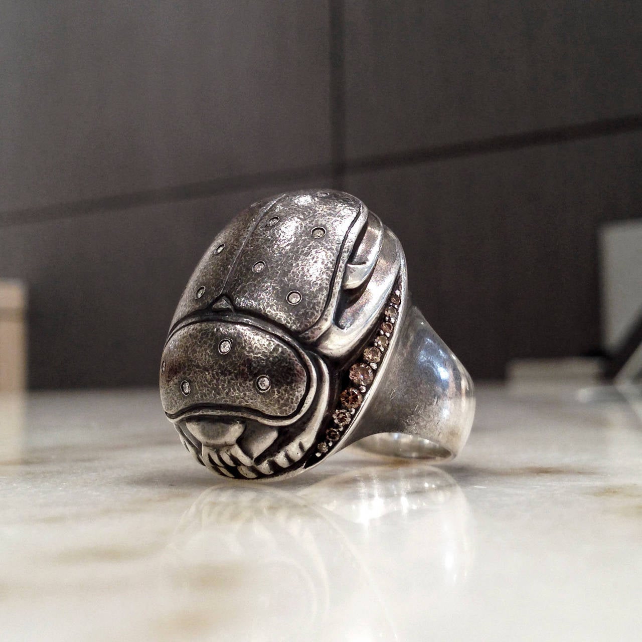 One-of-a-kind Scarab Ring handcrafted in oxidized sterling silver with embedded white, round brilliant-cut diamonds and prong-set cognac diamond side accents. Size 6.5 (Can be Sized).