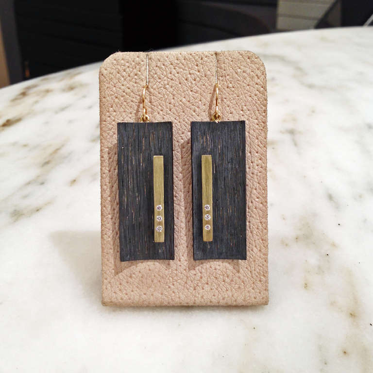 Diamond Bar Earrings in oxidized sterling silver with 18k yellow gold bars, six diamonds (0.18tcw) and 18k yellow gold wires. The oxidized sterling silver has a brilliant sheen when capturing light.