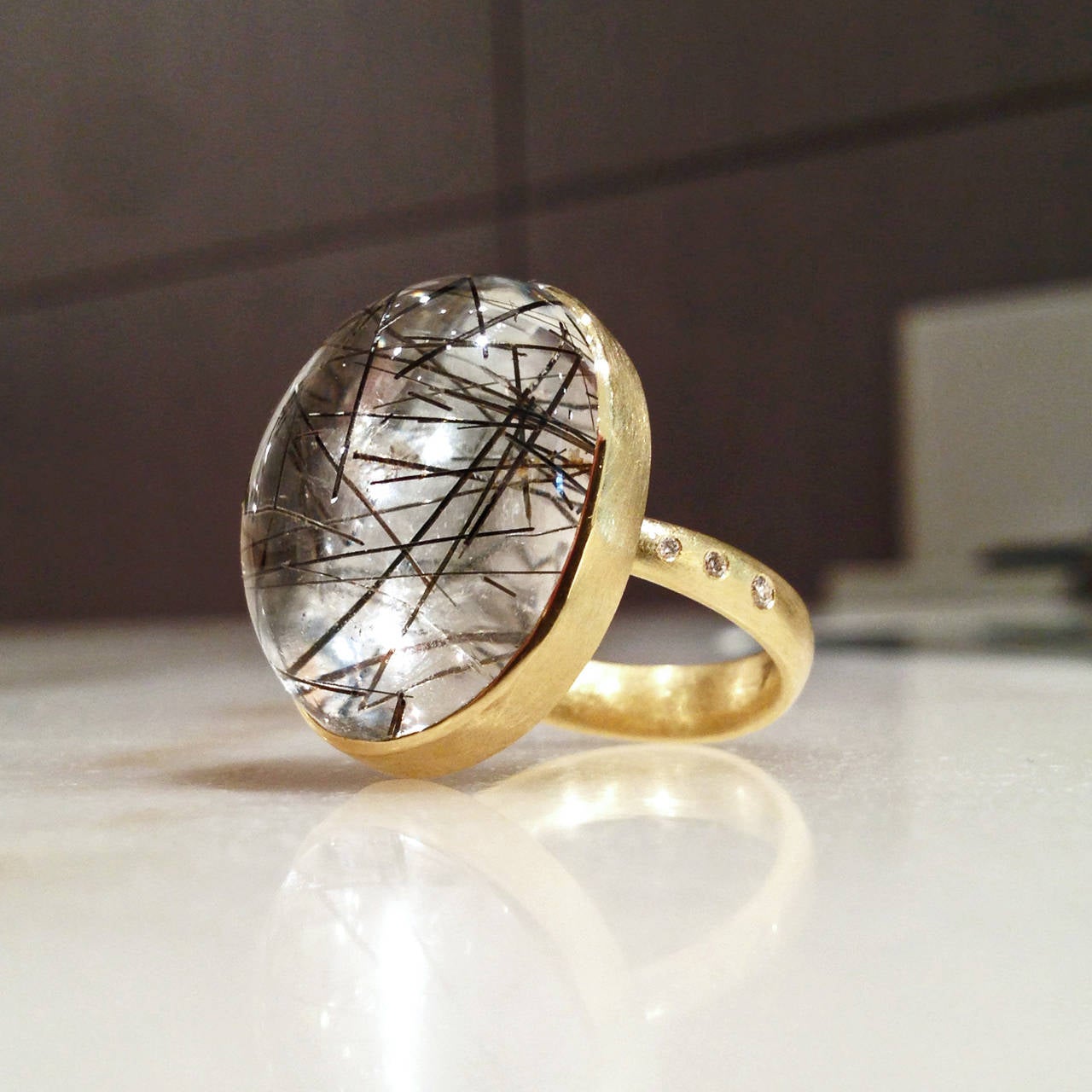 One-of-a-Kind Ring handcrafted in 18k yellow gold with a cabochon-cut black-needled rutilated quartz laid over palladium and accented with six round brilliant-cut VS1 white diamonds totaling 0.05 carats. Size 6.75 (can be sized).