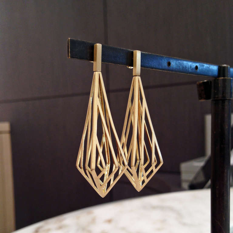 Three Dimensional Prism Cage Earrings crafted in 18k yellow gold with 18k posts connected to flexible rods that allow for slight oscillation of the cage elements.
