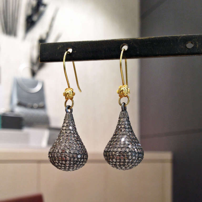Handcrafted Kiss Earrings with diamonds set in sterling silver on 14k yellow gold ear wires.