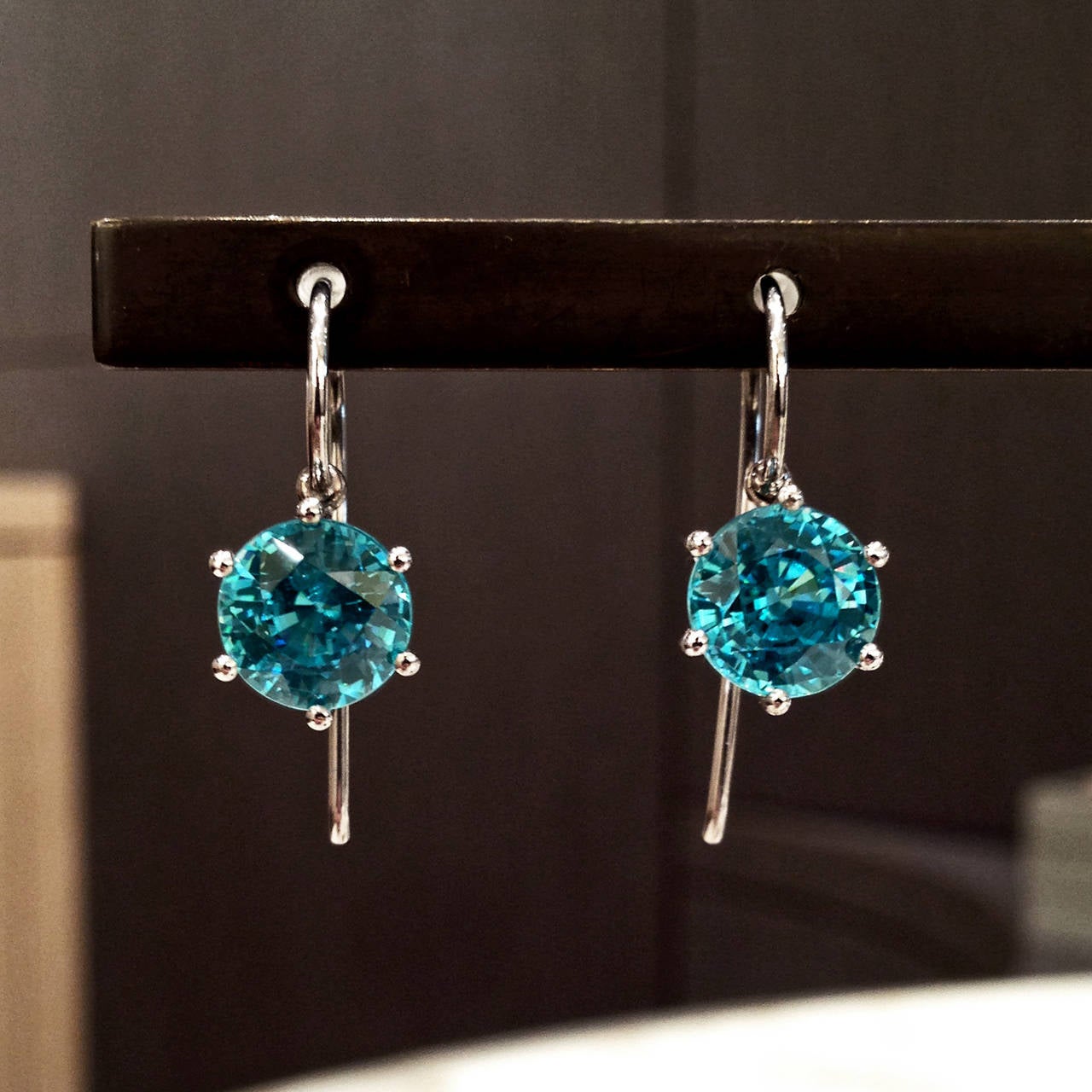 One-of-a-Kind Princess Earrings handcrafted in 18k white gold with a matched pair of spectacular 8mm blue zircon totaling 15.54 carats.