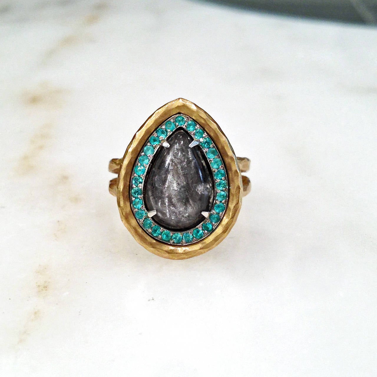 One-of-a-Kind Empress Ring handcrafted in 'crushed' 18k yellow gold with a 3.57 carat pear-shaped, cabochon-cut platinum rutilated quartz surrounded by 0.22 carats of Brazilian Paraiba tourmaline set in 18k white gold. Size 6.25 (can be sized).