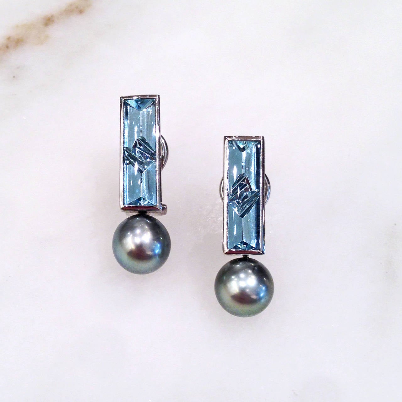 One-of-a-kind Blue Smoke Earrings handcrafted in platinum by world renowned master gem cutter and metal smith Atlier Munsteiner with 4.14 total carats of signature icicle-cut aquamarine and accented with two lustrous Tahitian pearls. Earrings