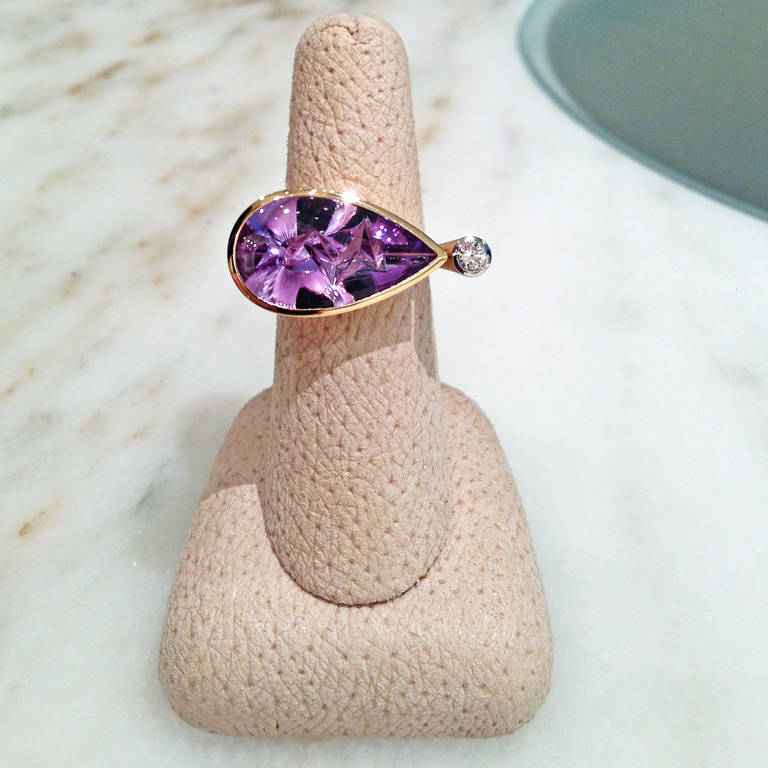 One-of-a-Kind Ring handcrafted by world-renowned Atelier Munsteiner in Germany, featuring a 8.90 carat hand-cut purple amethyst and accented with one 0.15 carat round brilliant-cut VS1 white diamond. Size 7.25 (can be sized).

The ring weighs a