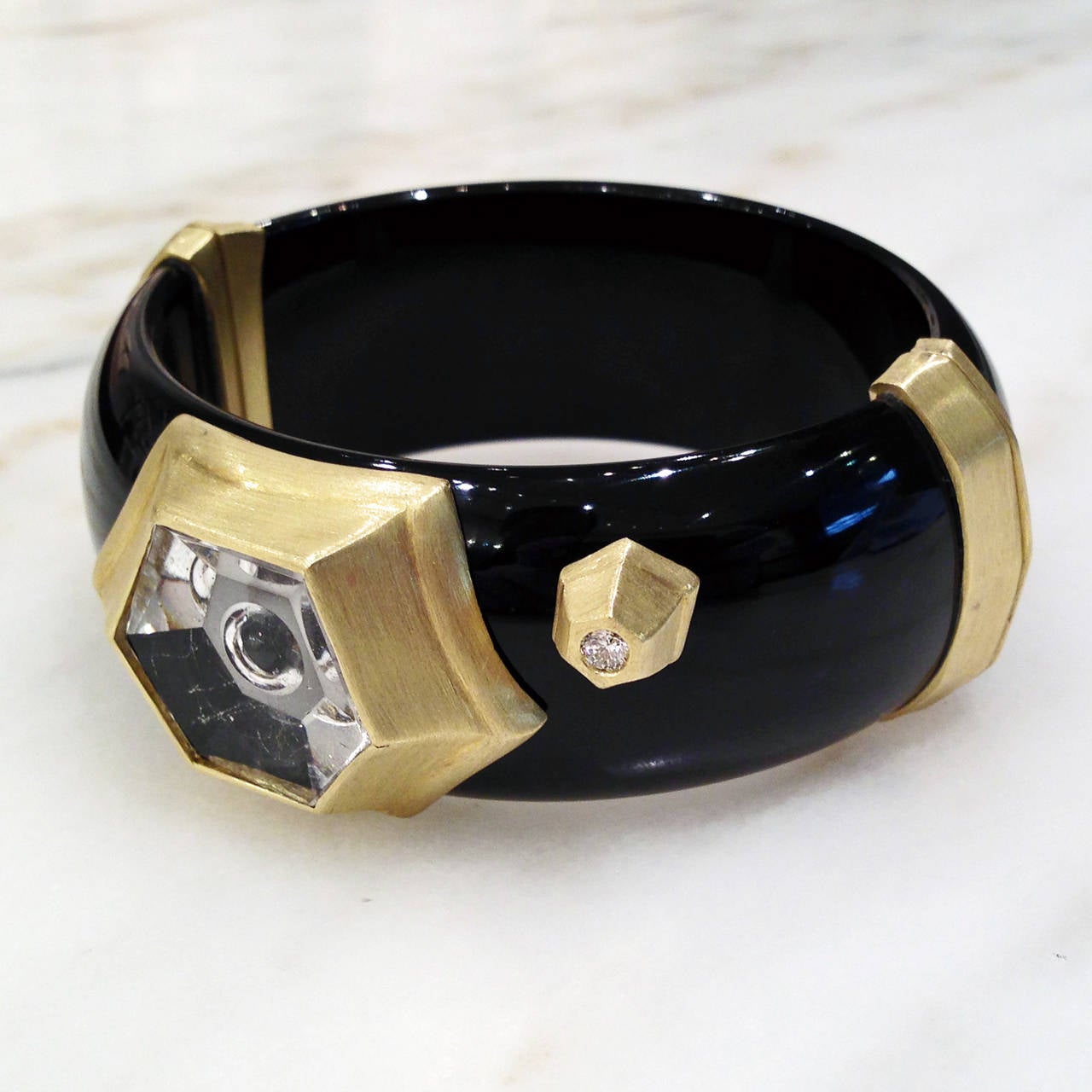 One-of-a-Kind black bakelite bracelet handcrafted by jewelry artist Susan Sadler showcasing an 18.56 carat Munsteiner "bubble-cut" rutilated quartz with exceptional reflective qualities, and accented with a 0.15 carat round, brilliant-cut