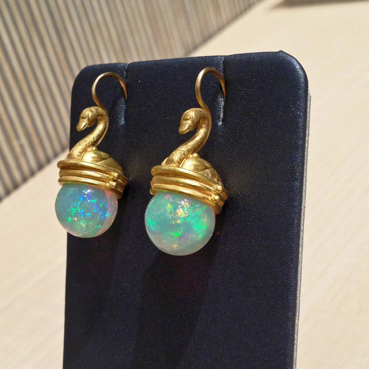 One-of-a-Kind Swan Earrings handcrafted in 22k yellow gold with exceptional and rare hand-carved white Ethiopian Opal spheres. Opals have jelly qualities. 

About the Artist: Lilly is a studio goldsmith working in high karat gold making objects