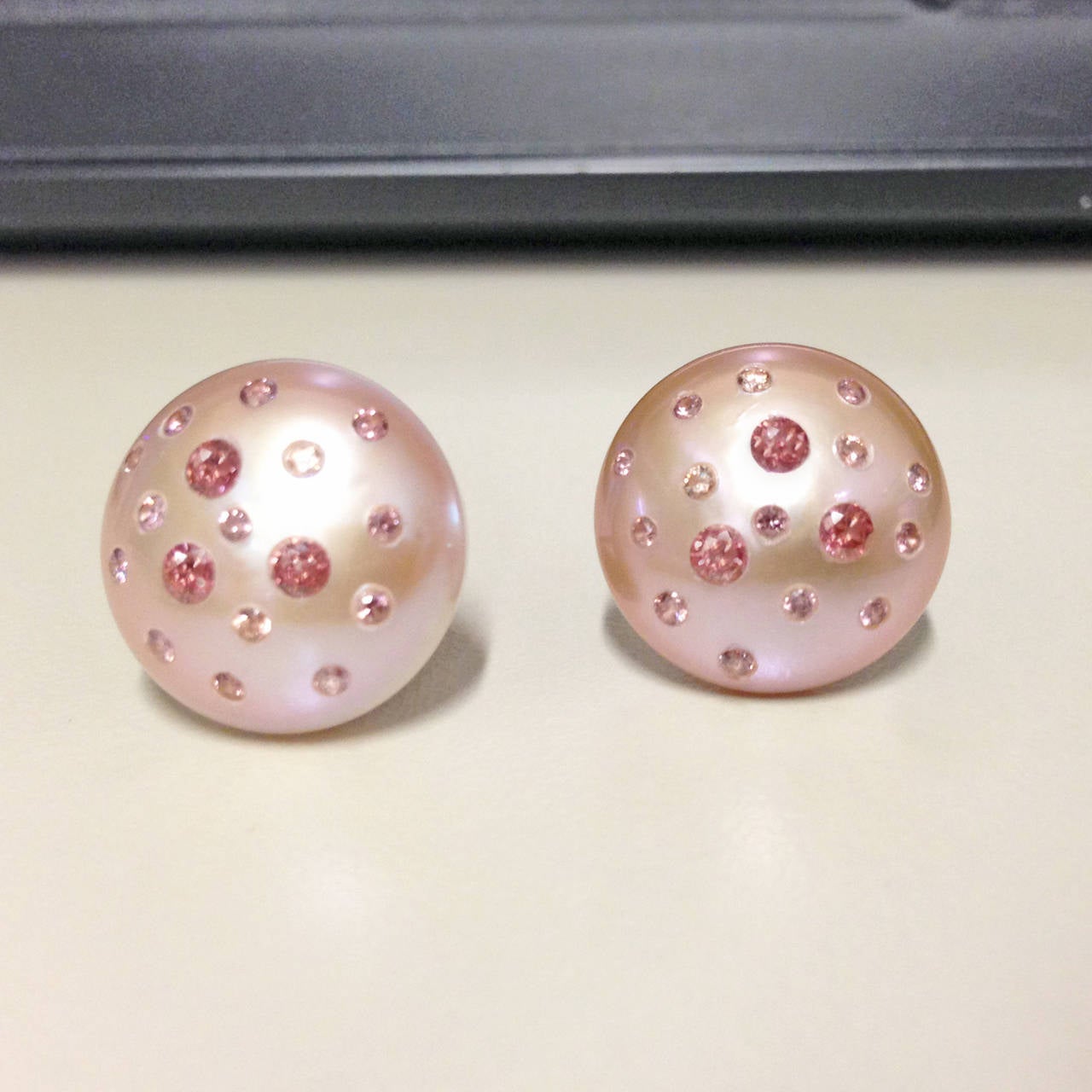 One-of-a-Kind Pink Freshwater Button Pearl Earrings (16mm) set with handmade 18k yellow gold leaf backs with 0.90 total carats of embedded pink diamonds.
