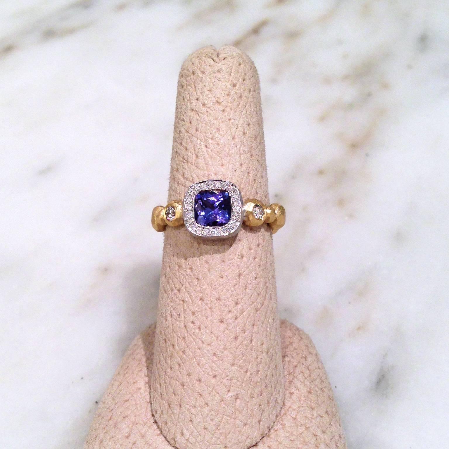 One-of-a-Kind Ring featuring a stunning 1.07 carat cushion-cut purplish-blue tanzanite bezel-set in 18k white gold with a pave' diamond border on a 'crushed' 18k yellow gold beaded shank showcasing two bezel-set round brilliant-cut diamonds. Size