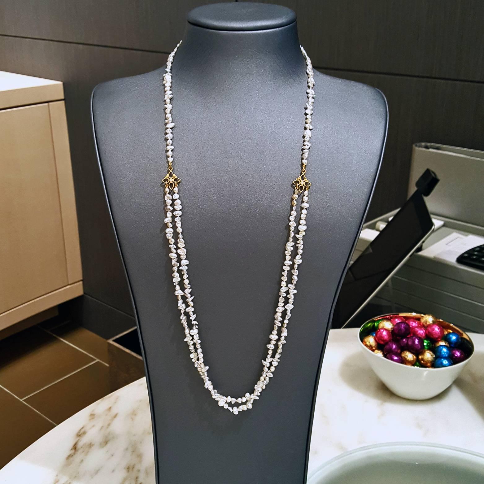 One-of-a-Kind 36" Double Strand Necklace with mixed blue and silver-toned Keshi pearls and complemented by two handmade 22k yellow gold cottonwood stations showcasing 0.06 total carats of round, brilliant-cut white diamonds.