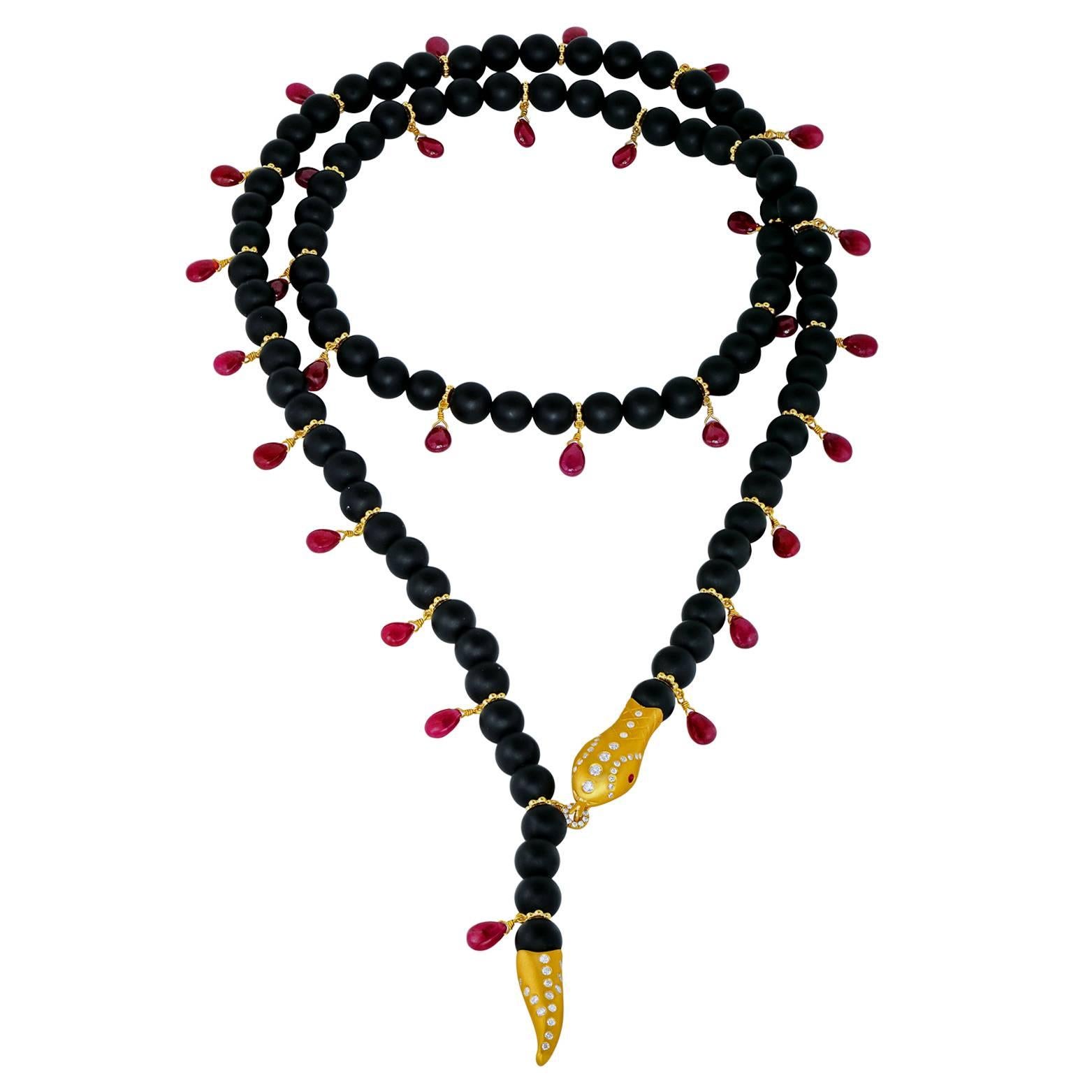 One-of-a-Kind  Rattlesnake Necklace handcrafted with smooth, satin-finished black onyx and ruby briolettes attached to 18k yellow gold rondels, and showcasing a diamond-encrusted (0.63tcw G/H, vs2/si1) 22k yellow gold rattlesnake tail and head with