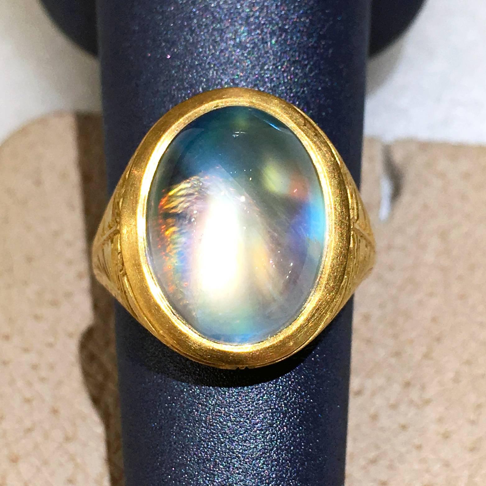 One of a Kind Relic Ring handcrafted in 22k yellow gold with a Sri Lankan oval cabochon-cut rainbow moonstone showcasing a remarkable spectrum of color that shifts with even the slightest of movements. Size 6.5 (can be sized). 