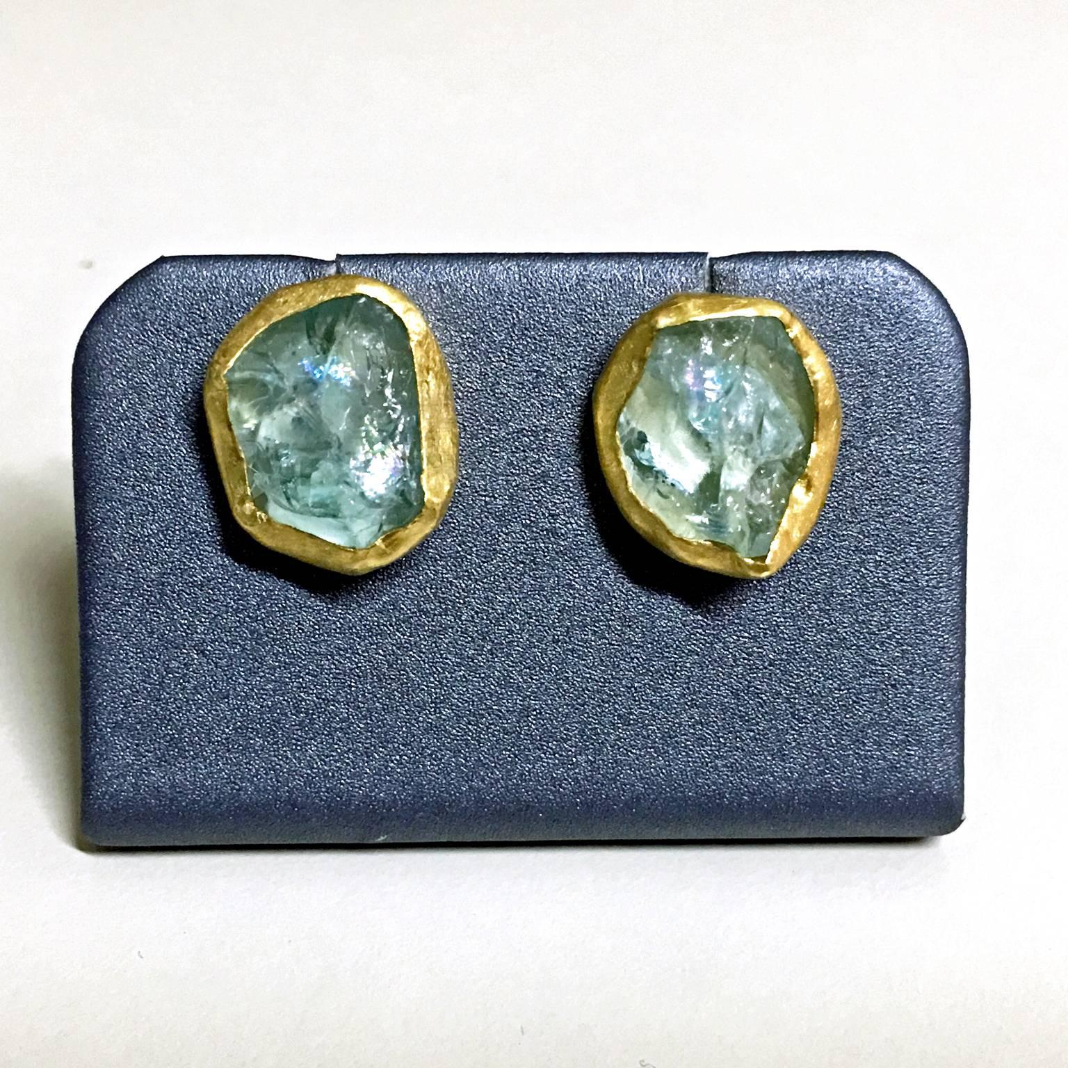 One-of-a-Kind Earrings handcrafted in 22k yellow gold with aquamarine crystals showcasing beautiful rainbow flashes from multiple angles.