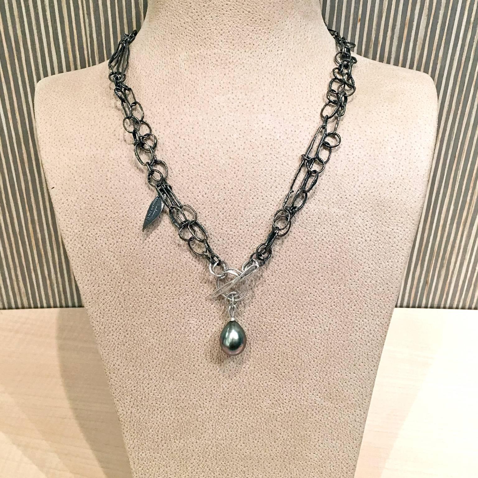 One-of-a-Kind Double Link Necklace on a handcrafted oxidized sterling silver multi-element double link chain that seamlessly blends into an 18k white gold open toggle clasp with a brilliant teardrop-shaped Tahitian pearl drop  showcasing beautiful