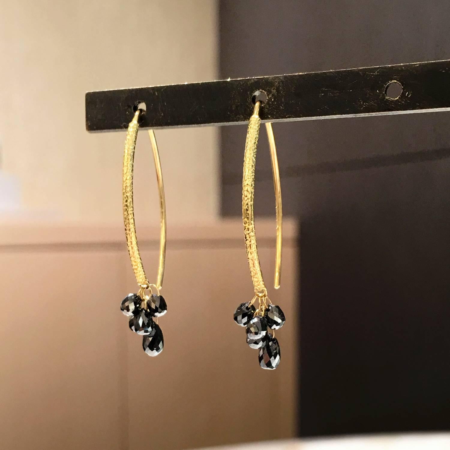 Drop Earrings handcrafted in matte-finished 18k yellow gold with 3.42 total carats of faceted black diamond briolettes attached by individual dangling 18k yellow gold loops. 