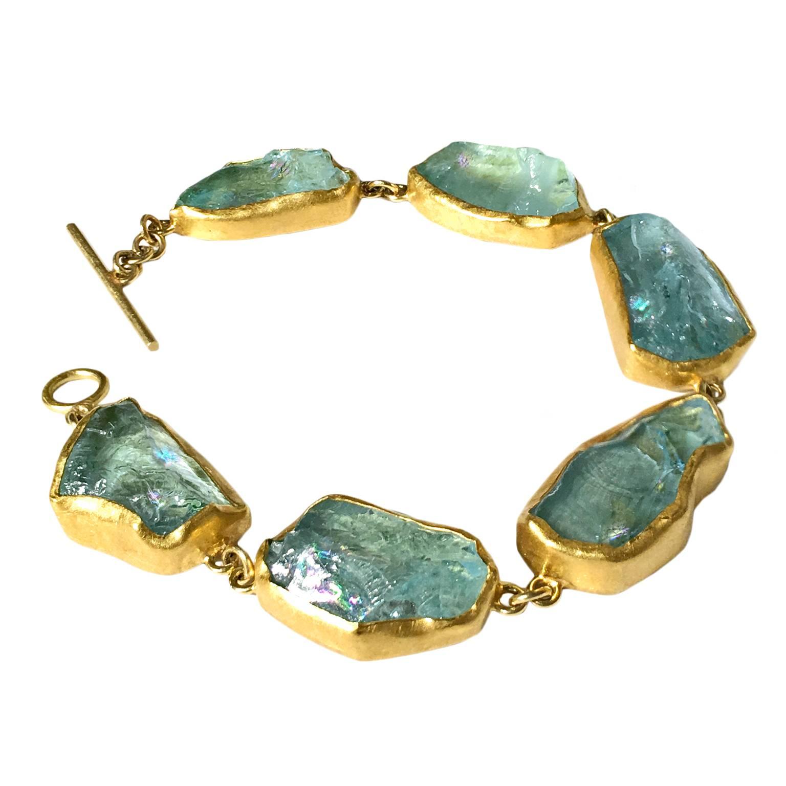 One-of-a-Kind Bracelet with five aquamarine crystals (90 carats) showcasing beautiful rainbow flashes, bezel-set in handcrafted 22k yellow gold with an 18k yellow gold toggle clasp. 