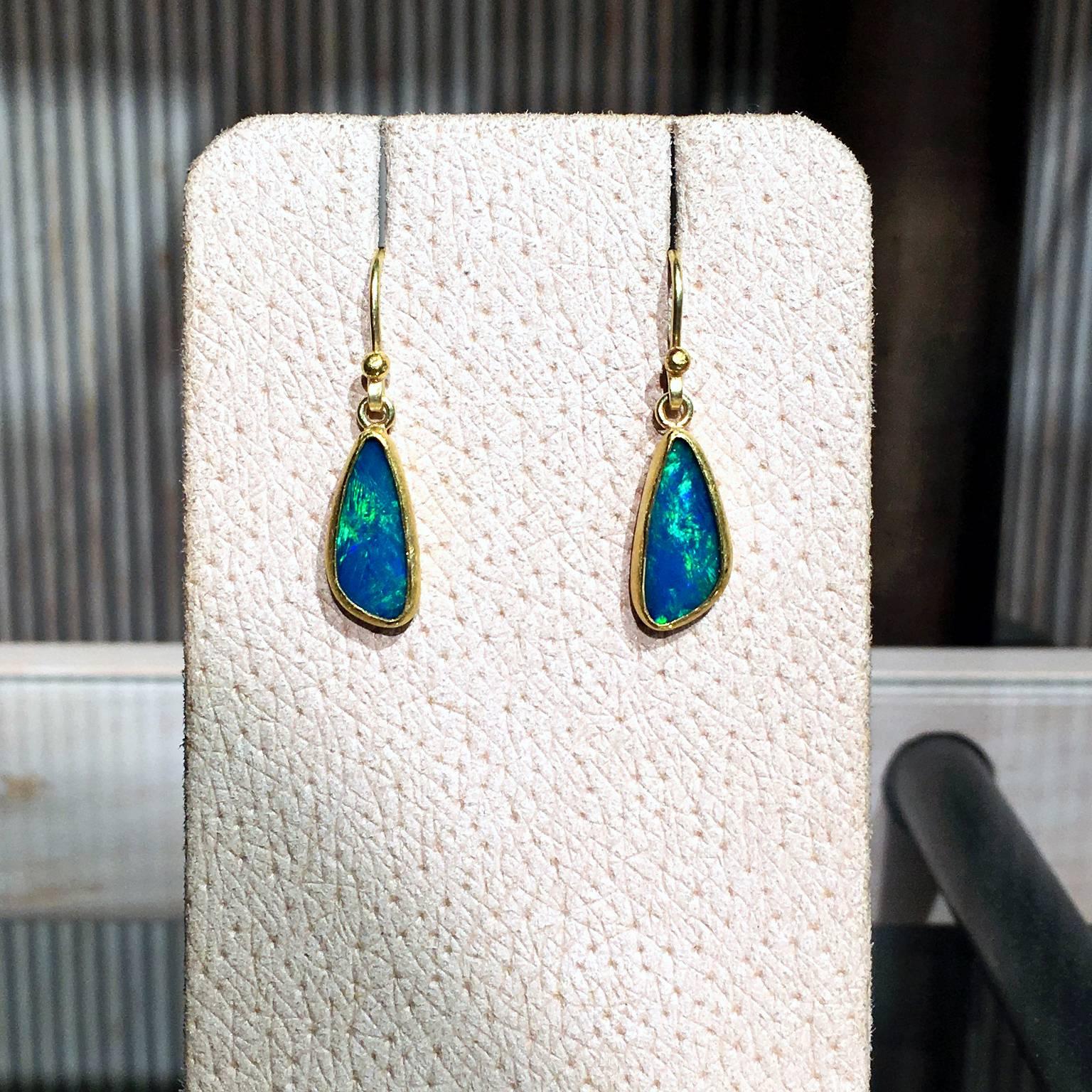Dangling Drop Earrings handcrafted by Petra Class in her signature 22k yellow gold finish with two bezel-set Australian blue opal doublets showcasing a beautiful green flash and on 18k yellow gold wires.

Stamped and Hallmarked 18k / 22k / PC