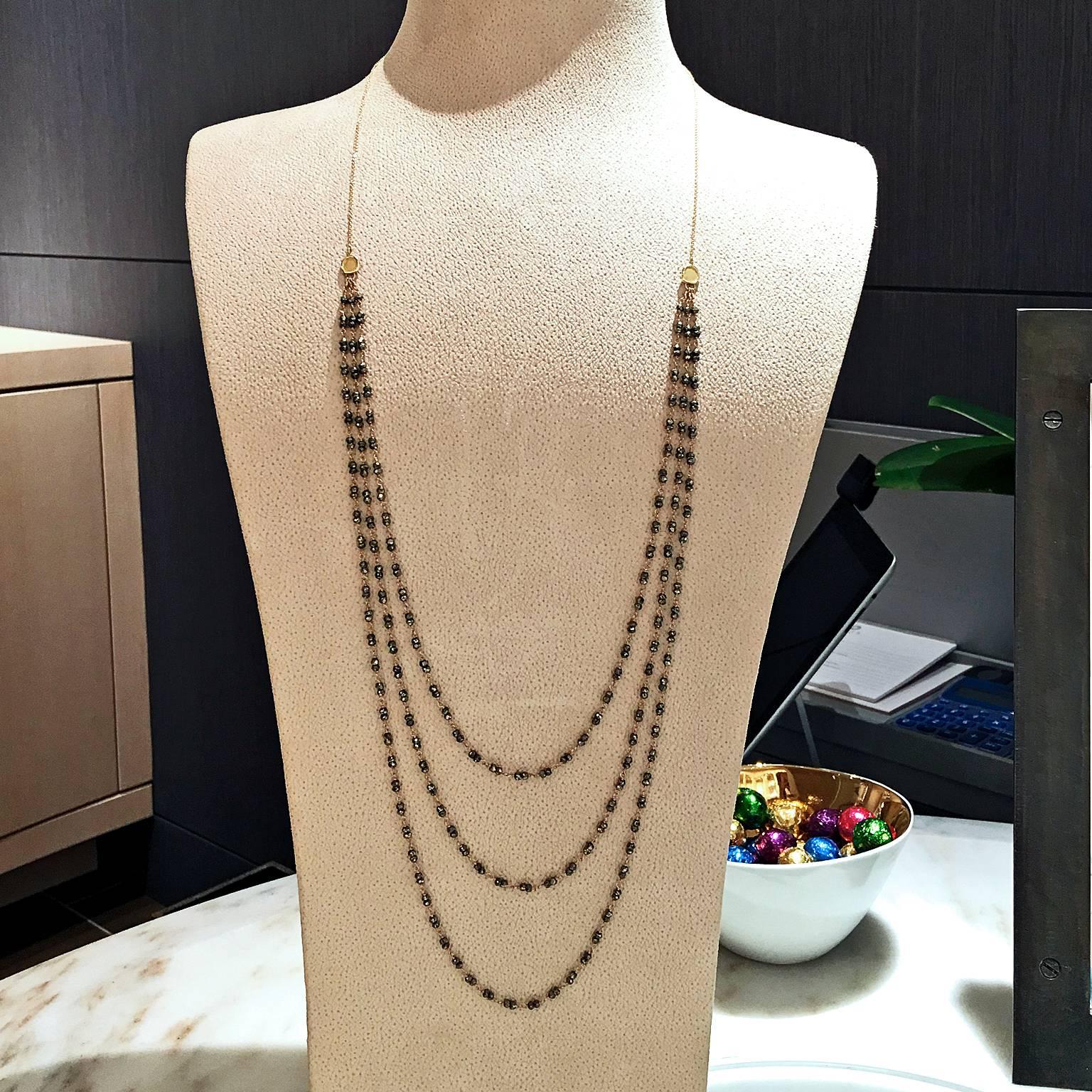Shimmering Triple Strand Necklace handcrafted in matte finished 18k yellow gold with faceted pyrite beads, two 18k yellow gold coin accents and an 18k yellow gold lobster clasp.

Necklace is stamped 18k / 750 , and is hallmarked AS
