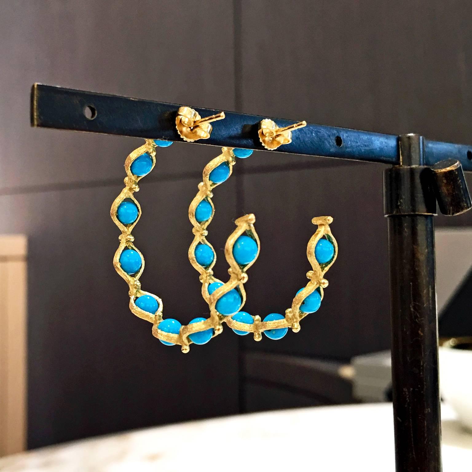 Infinity Hoop Earrings handcrafted by Joseph Murray with his signature 18k yellow gold finish wrapped around 18 turquoise sphere rolling beads, and accented with gold granulation. 