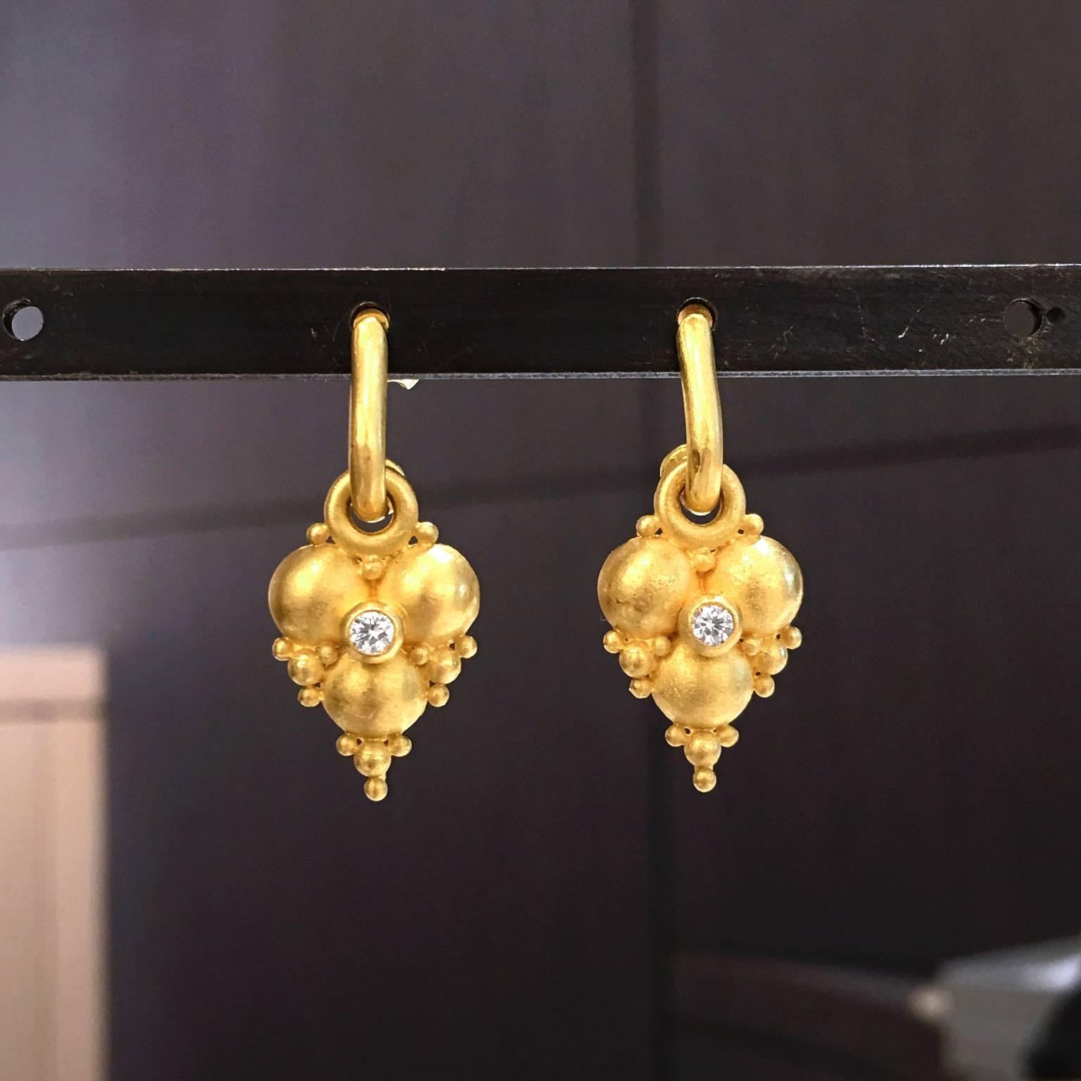 Heart Earrings handcrafted by renowned jewelry artist Denise Betesh with two bezel-set round brilliant-cut white diamonds totaling 0.10 carats and surrounded by assorted sizes of the artist's signature 22k yellow gold matte finish and hand-rolled