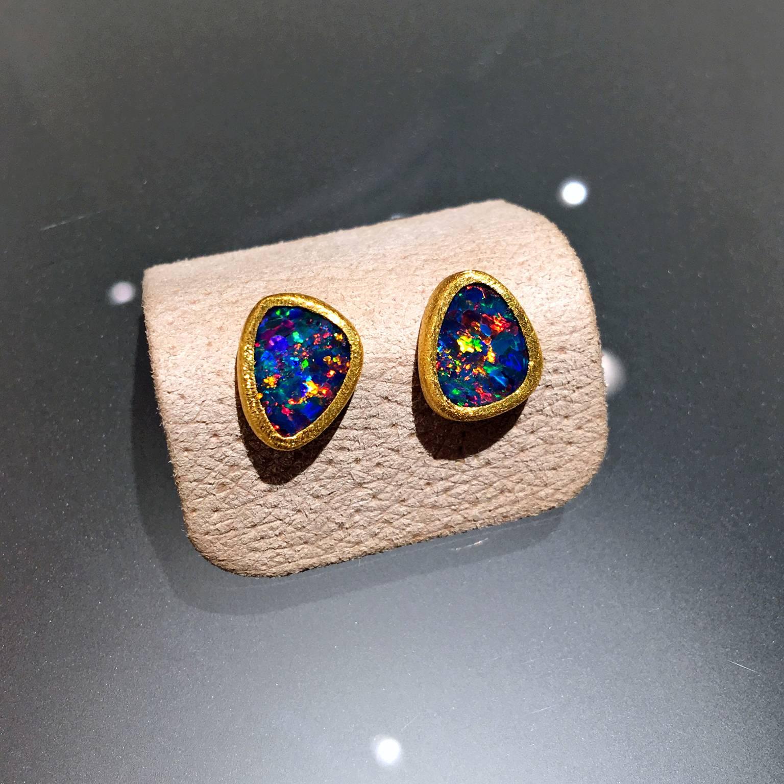 One-of-a-Kind Stud Earrings handcrafted by acclaimed jewelry designer Devta Doolan with bluish violet opal doublets exhibiting a unique and vibrant rare red flash with electrifying accents of green, orange, blue, yellow, violet, and purple fire. The