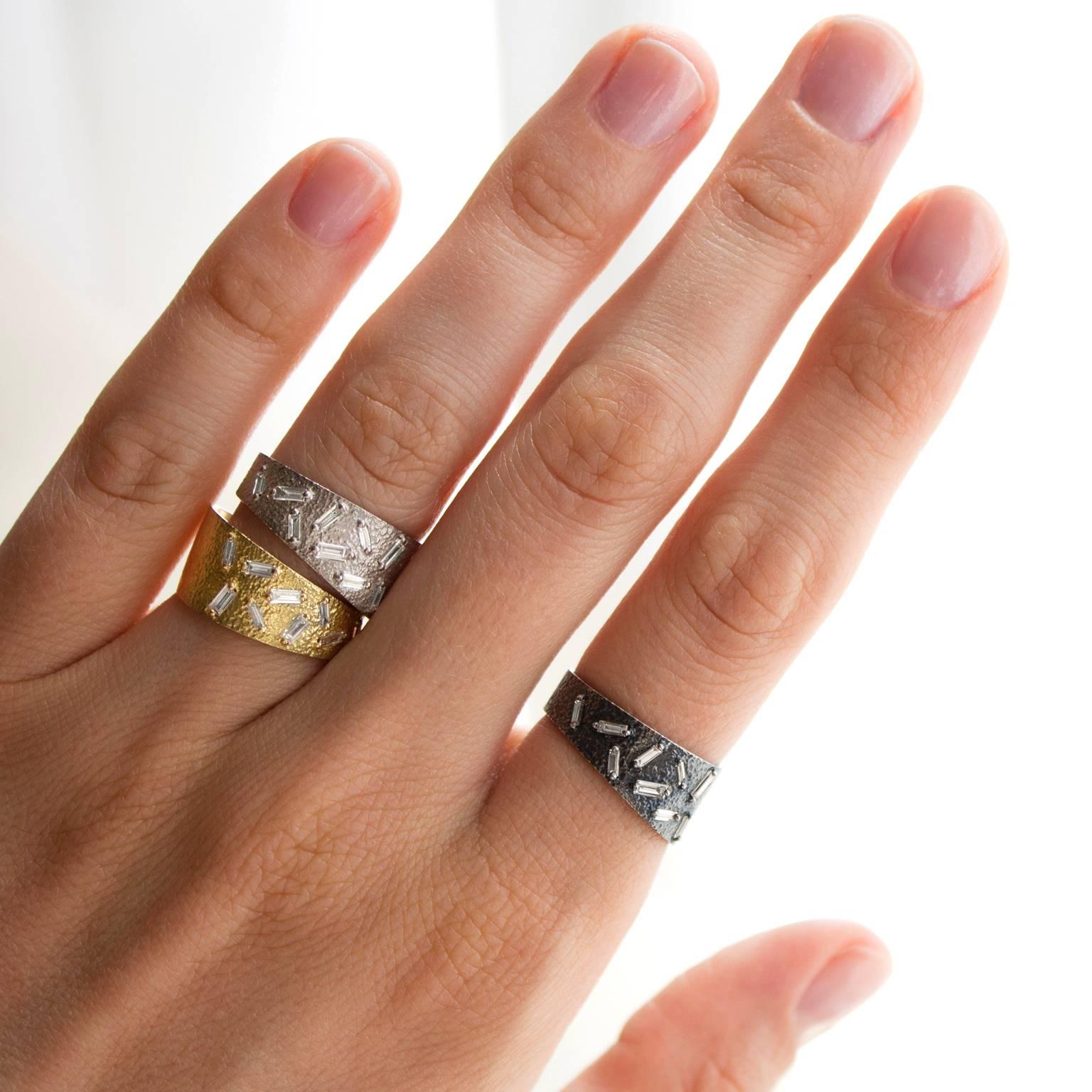 Curved Stacking Band Rings handcrafted in 18k yellow gold and oxidized sterling silver with 18 white diamond baguettes totaling 0.5596 carats set with polished double prongs. Price includes both rings, but each can be purchased
