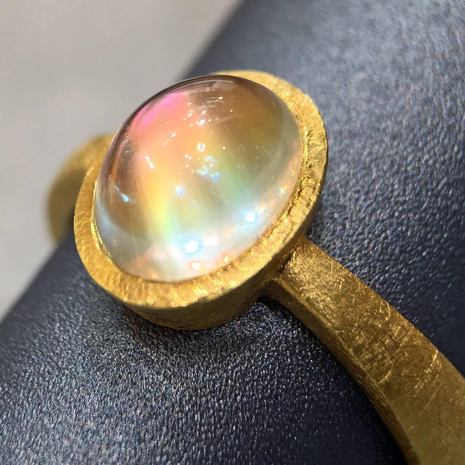 One of a Kind Ring handmade by renowned jewelry designer Devta Doolan showcasing an exceptional quality and very unusual orange rainbow moonstone with vibrant flash featuring all colors of the rainbow. The extraordinary gemstone is bezel-set on a