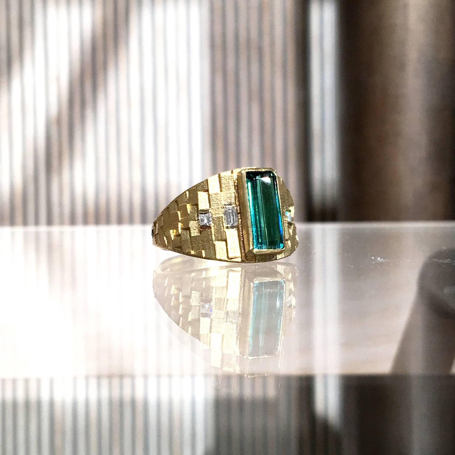 One of a Kind Tapered Deco Ring created by London-based jewellery artist Jo Hayes Ward showcasing a 1.30 carat bluish green tourmaline custom-cut baguette (10mm x 4mm), two white diamond baguettes, and two princess-cut white diamonds, all bezel-set