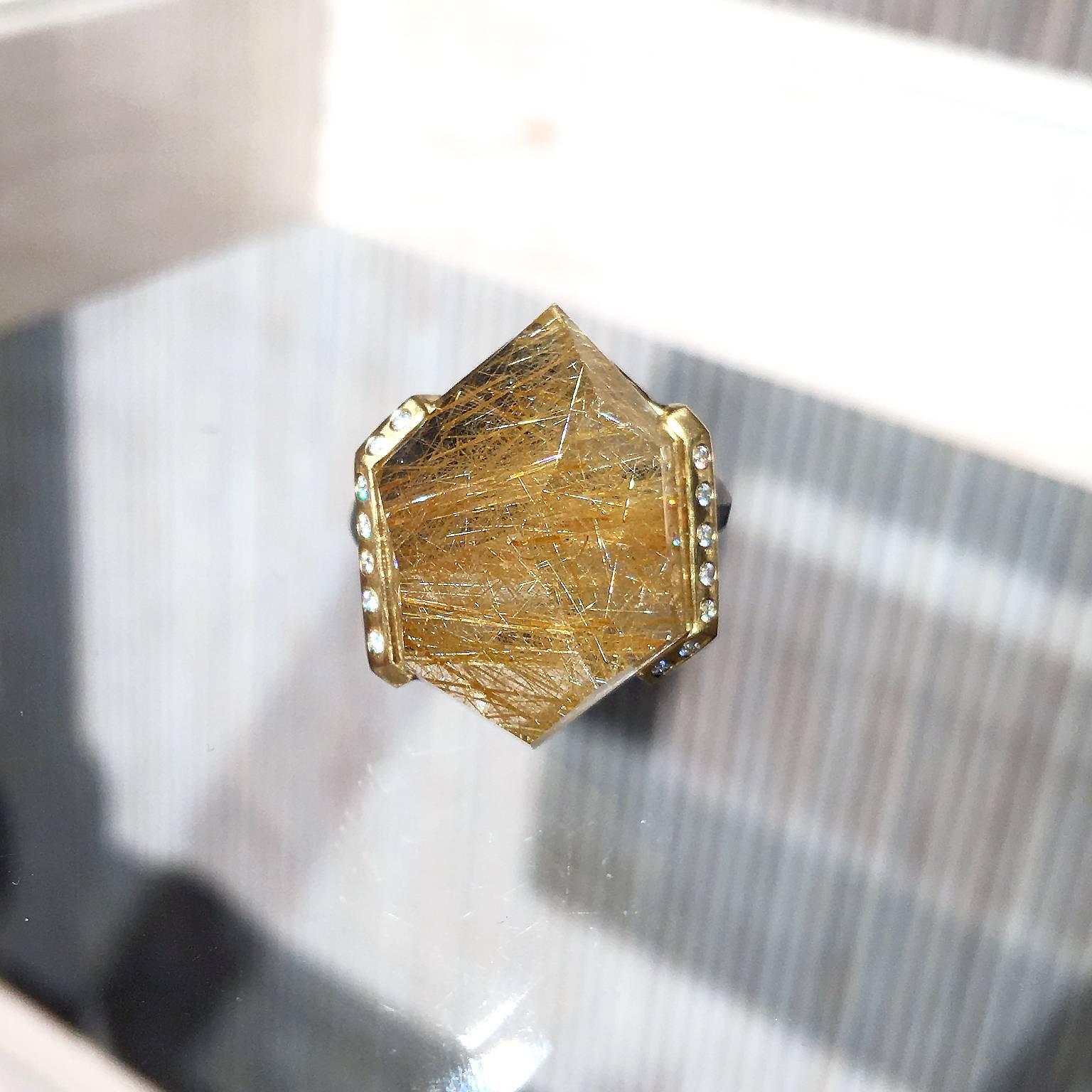 Facets ring handcrafted by jewelry designer Elizabeth Garvin with a spectacular, custom-cut rutilated quartz uniquely bezel-set in matte-finished 18k yellow gold with fourteen round brilliant-cut white diamond accents and a faceted 950 palladium