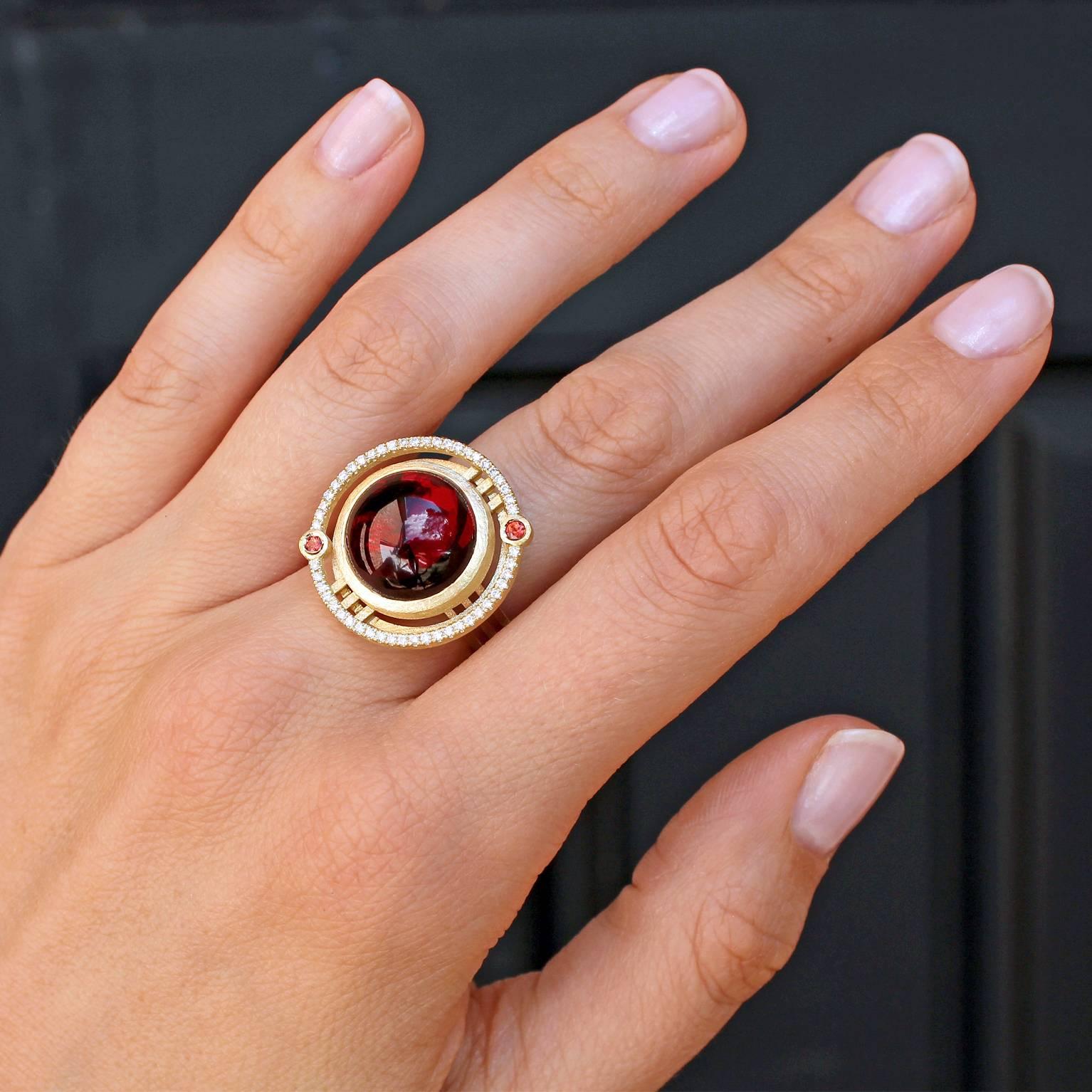 One of a Kind Nova Ring by London jewellery designers Shimell and Madden handcrafted in satin-finished 18k yellow gold featuring an extraordinary, glowing 14mm red garnet cabochon, and accented with 0.25 total carats of round brilliant-cut white