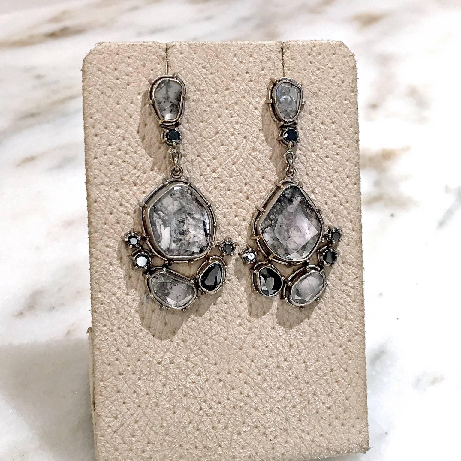 One of a Kind Earrings handcrafted in 18k white gold-palladium showcasing assorted shimmering gray and black faceted diamonds.

Stamped and Hallmarked 18k / Tura