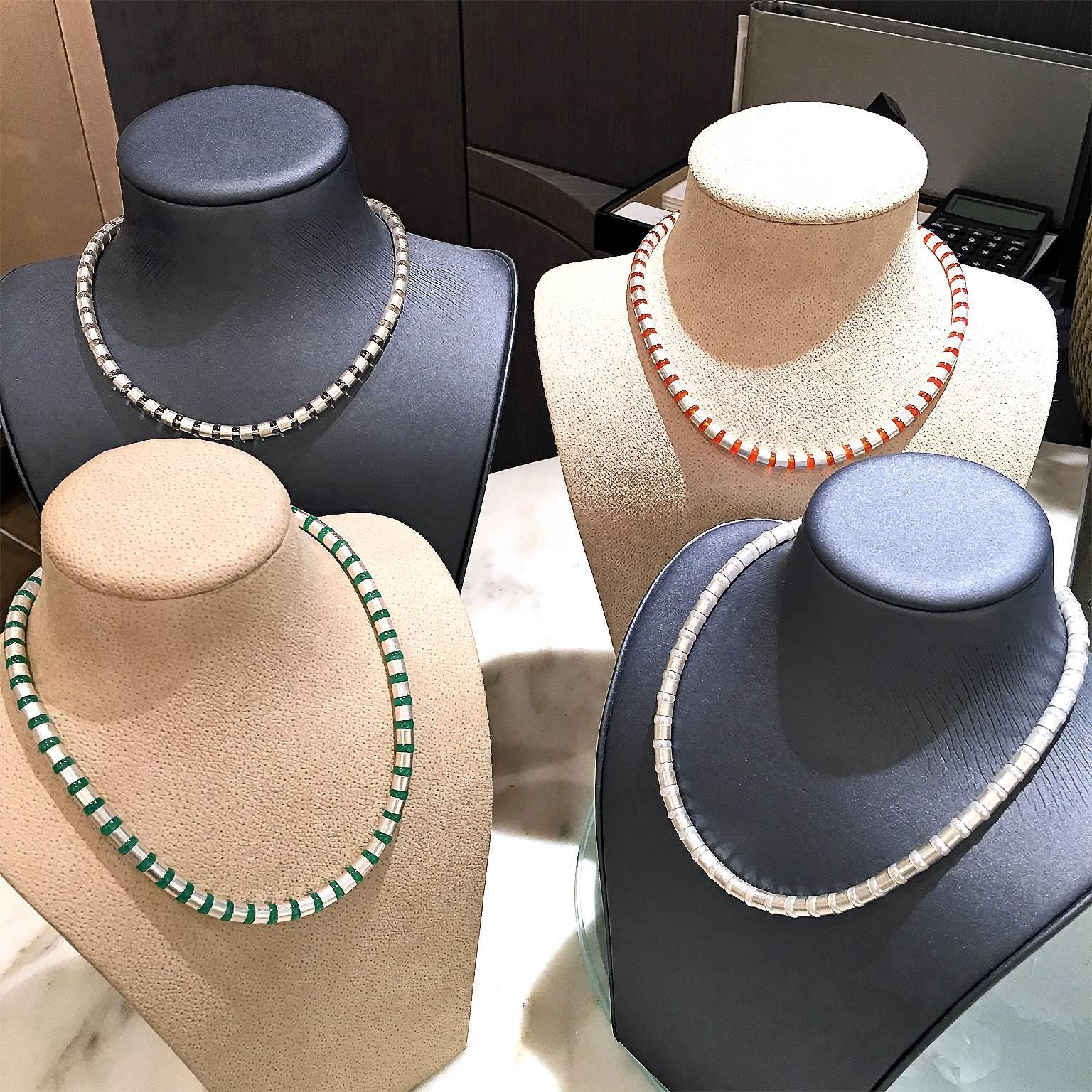 Four Cleopatra Necklaces handcrafted in Idar-Oberstein Germany by acclaimed master metalsmith and jewelry designer Erich Zimmermann. Each Necklace features dozens of individual handmade and matte-finished sterling silver cylindrical elements