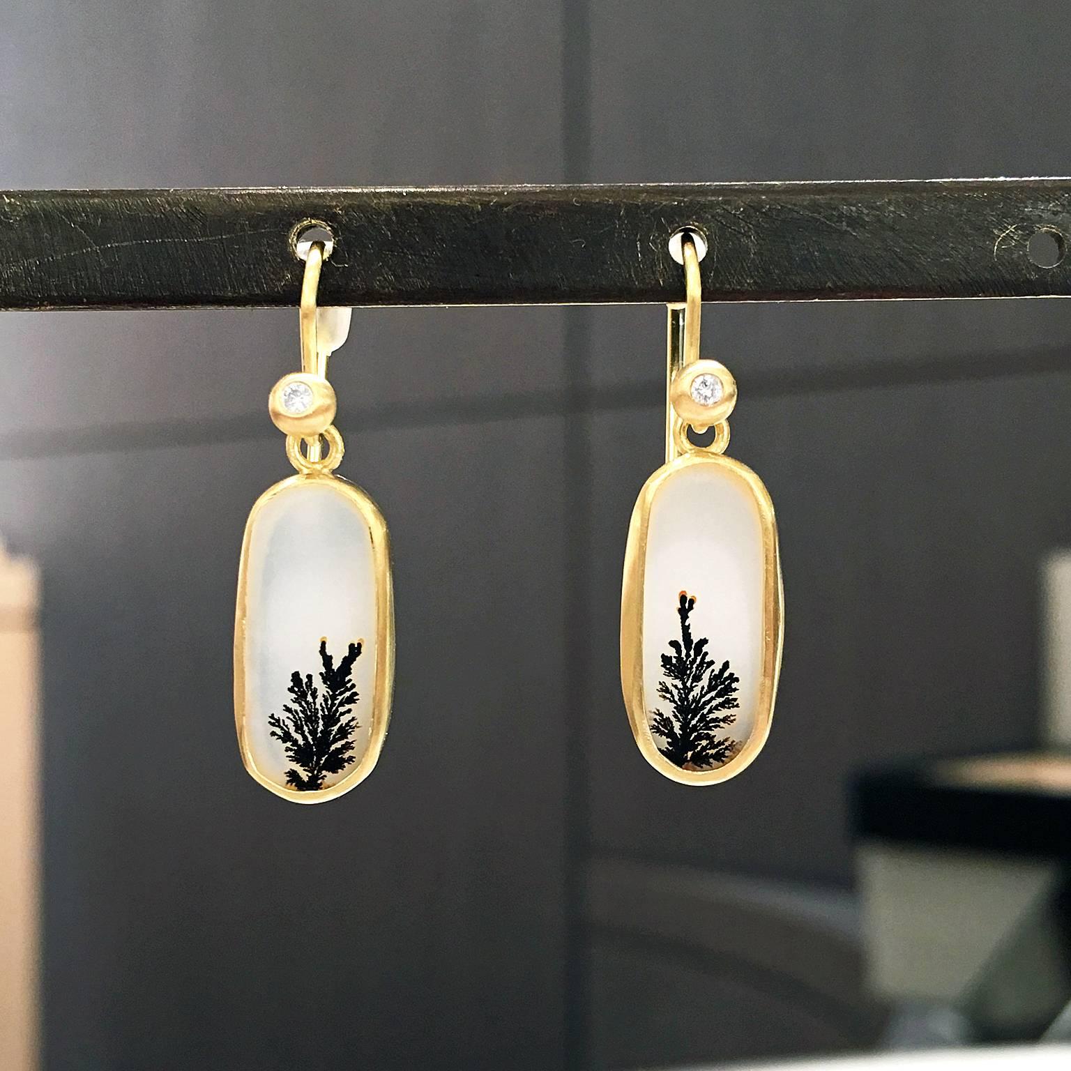 One of a Kind Dangle Earrings handcrafted in matte-finished 18k yellow gold showcasing a matched pair of translucent white and black dendrite agate, and accented by two round brilliant-cut white diamondss attached to 18k yellow gold ear wires.