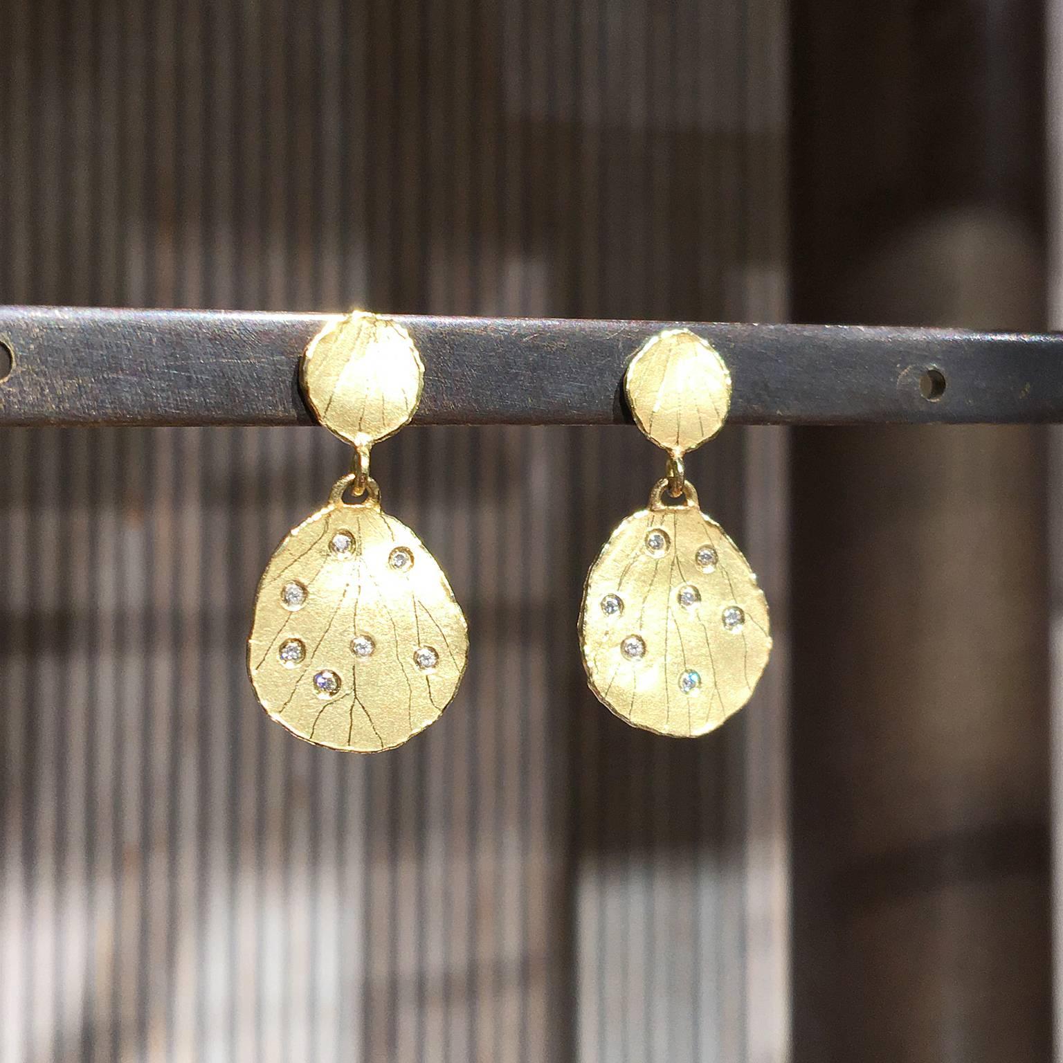 Petal Dangle Drop Earrings handcrafted in matte-finished 18k yellow gold by award-winning jewelry artist Barbara Heinrich with etched petal tops above dangling petal drops embedded with  fourteen 0.005 carat round brilliant-cut white diamonds