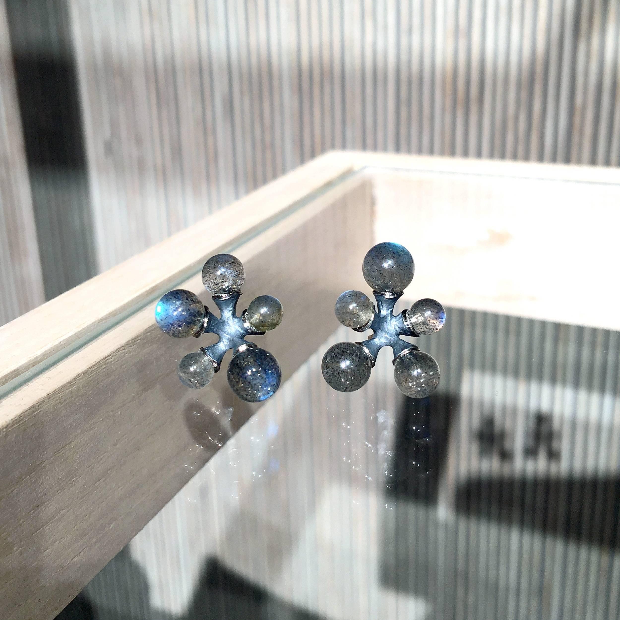 Micro Jacks Earrings handcrafted by renowned jewelry designer John Iversen in oxidized sterling silver with ten assorted size labradorite beads exhibiting strong labradorescence, flashing beautiful combinations of blue, violet, and green. on 18k