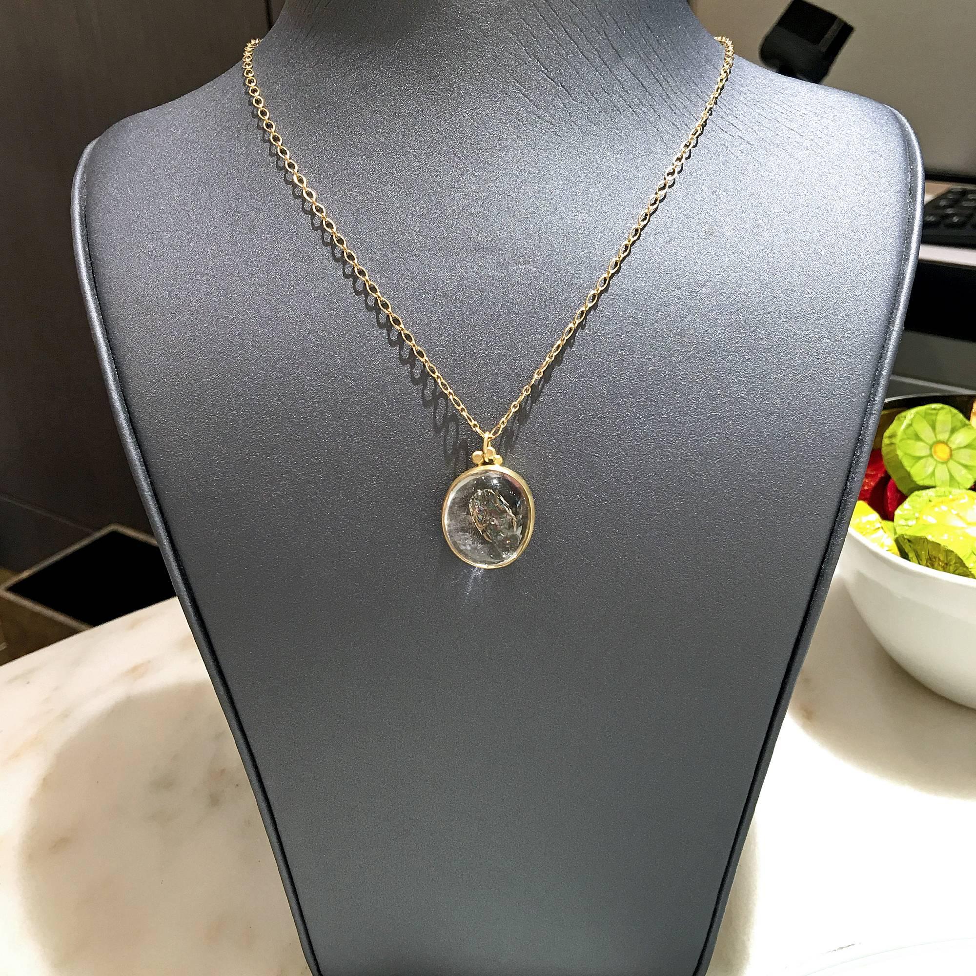 One of a Kind Necklace handcrafted by Monica Marcella in matte-finished 18k yellow gold featuring a unique enhydro quartz with a floating bubble in the center that circulates within the gemstone with any movement. The characteristics within the