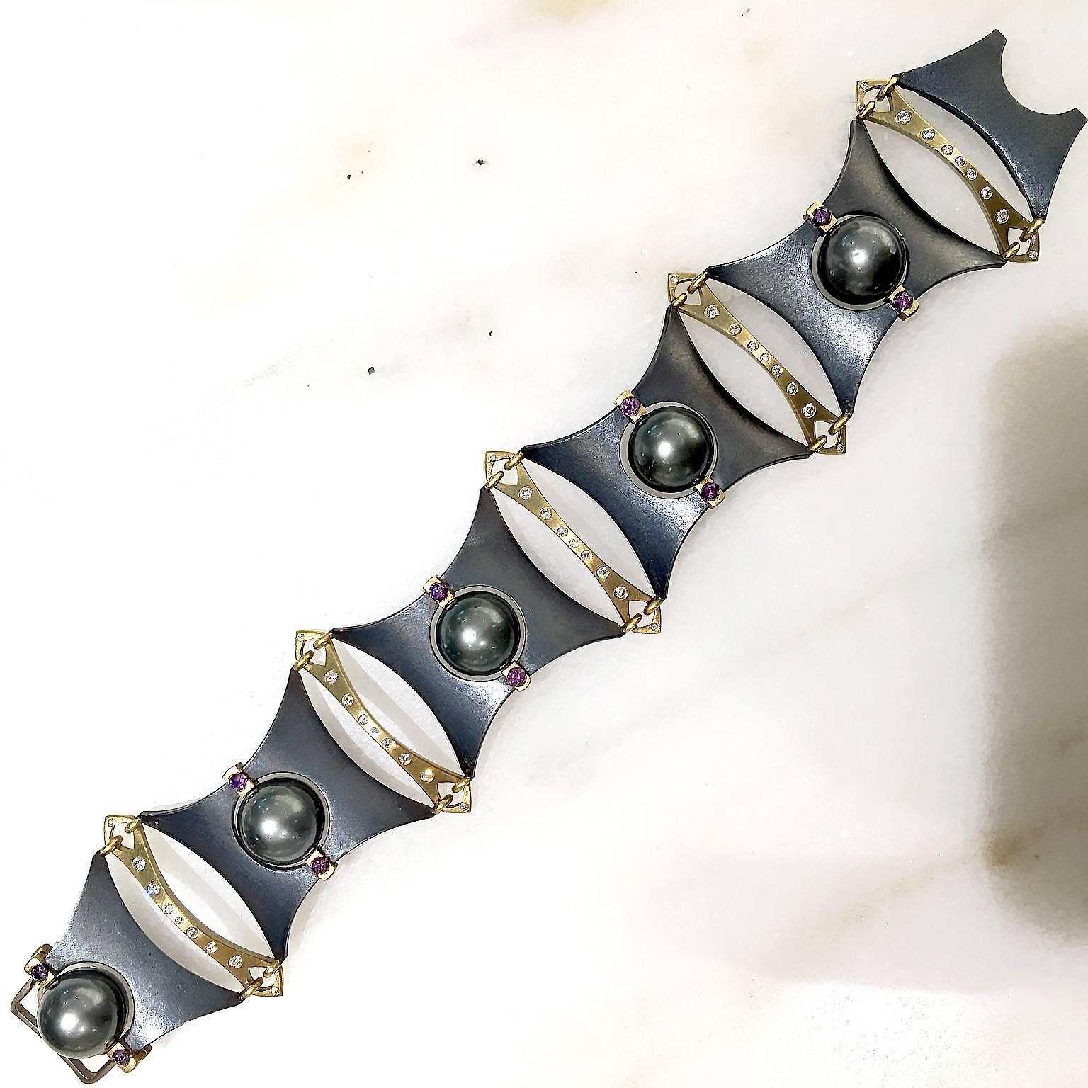 One of a Kind AXIS Bracelet handcrafted in matte finished 18k yellow gold and oxidized sterling silver by jewelry artist Robin Waynee. The intricate design features five 360 degree rotating 11.6mm Tahitian pearls, each flanked by two spectacular