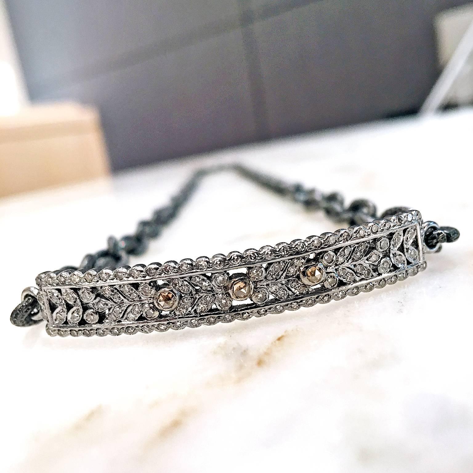 Double Wrap Bracelet handcrafted on a beautifully textured stainless steel chain featuring a curved sterling silver bar embedded with shimmering round brilliant-cut white diamonds and three rose-cut cognac diamond accents. 