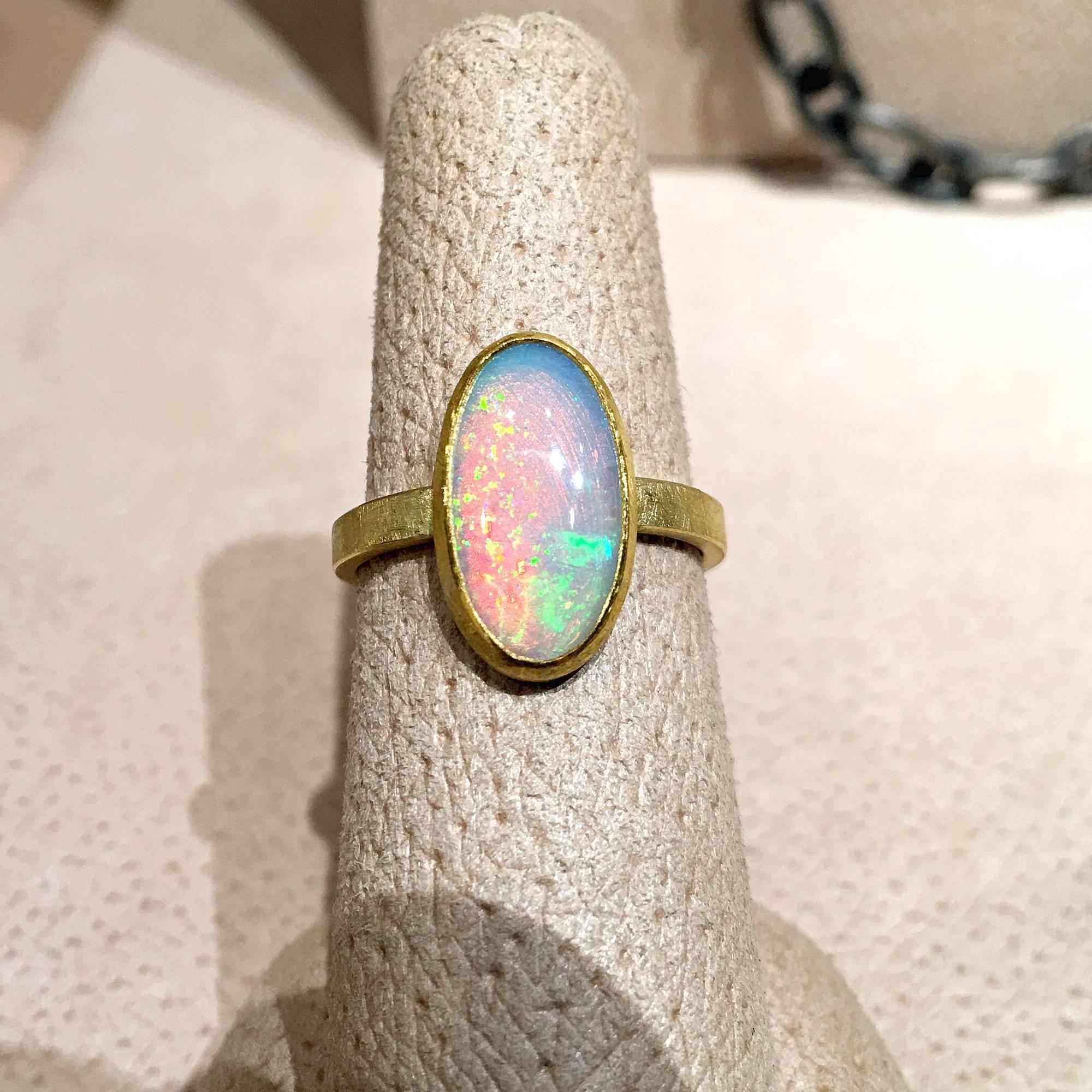 One of a Kind Ring handcrafted by jewelry designer Petra Class featuring a unique orangy-red glow 2.20 carat Ethiopian white opal with beautiful electric color-play, bezel-set in matte-finished 22k yellow gold and set on a handmade 18k yellow gold