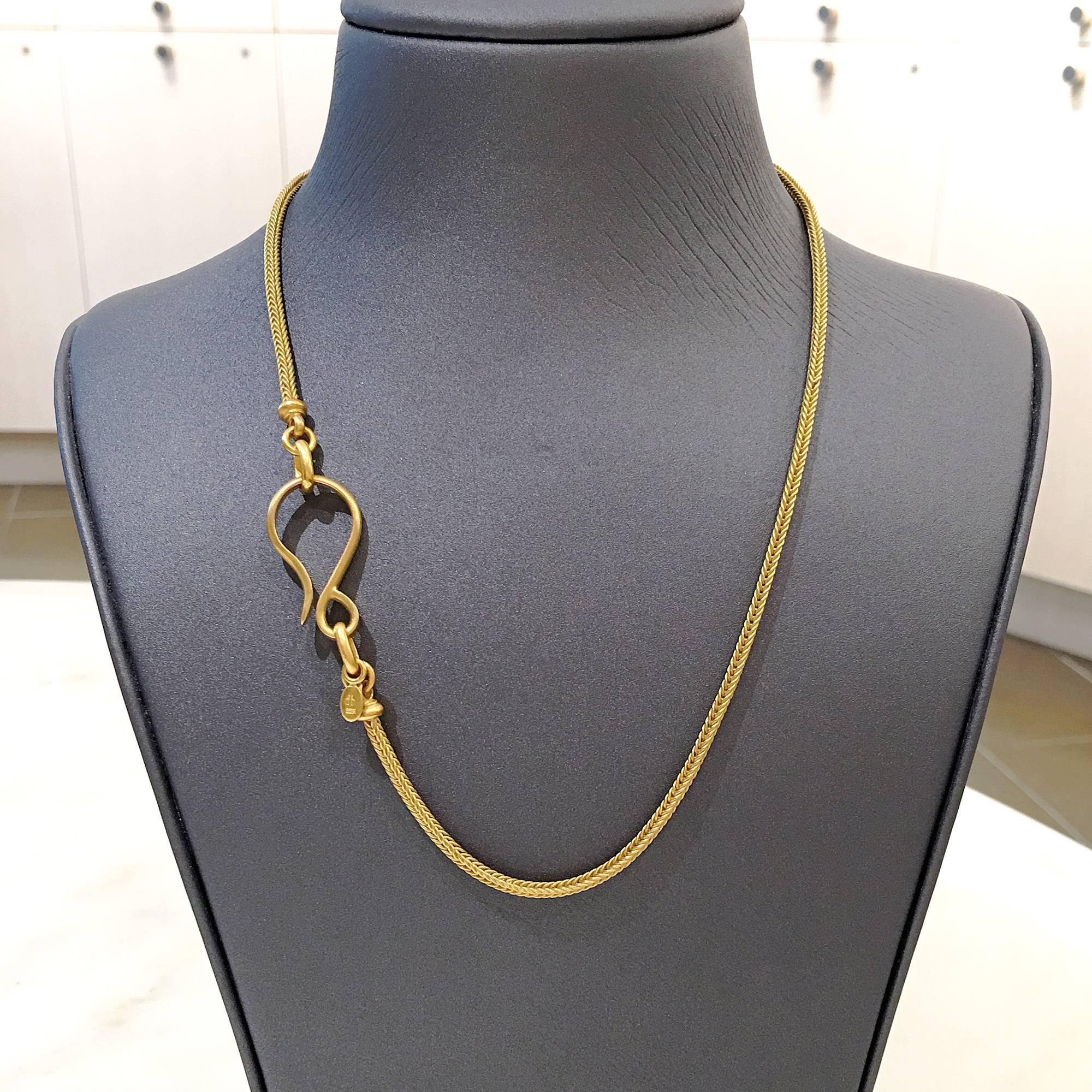 Intricate Handmade  Foxtail Chain by jewelry artist Denise Betesh showcasing the artist's signature-finished 22k yellow gold and a 1 inch ornamental hook clasp. A dangling oval coin features the designer's 'db' hallmark and 22k stamp. 18 inch in