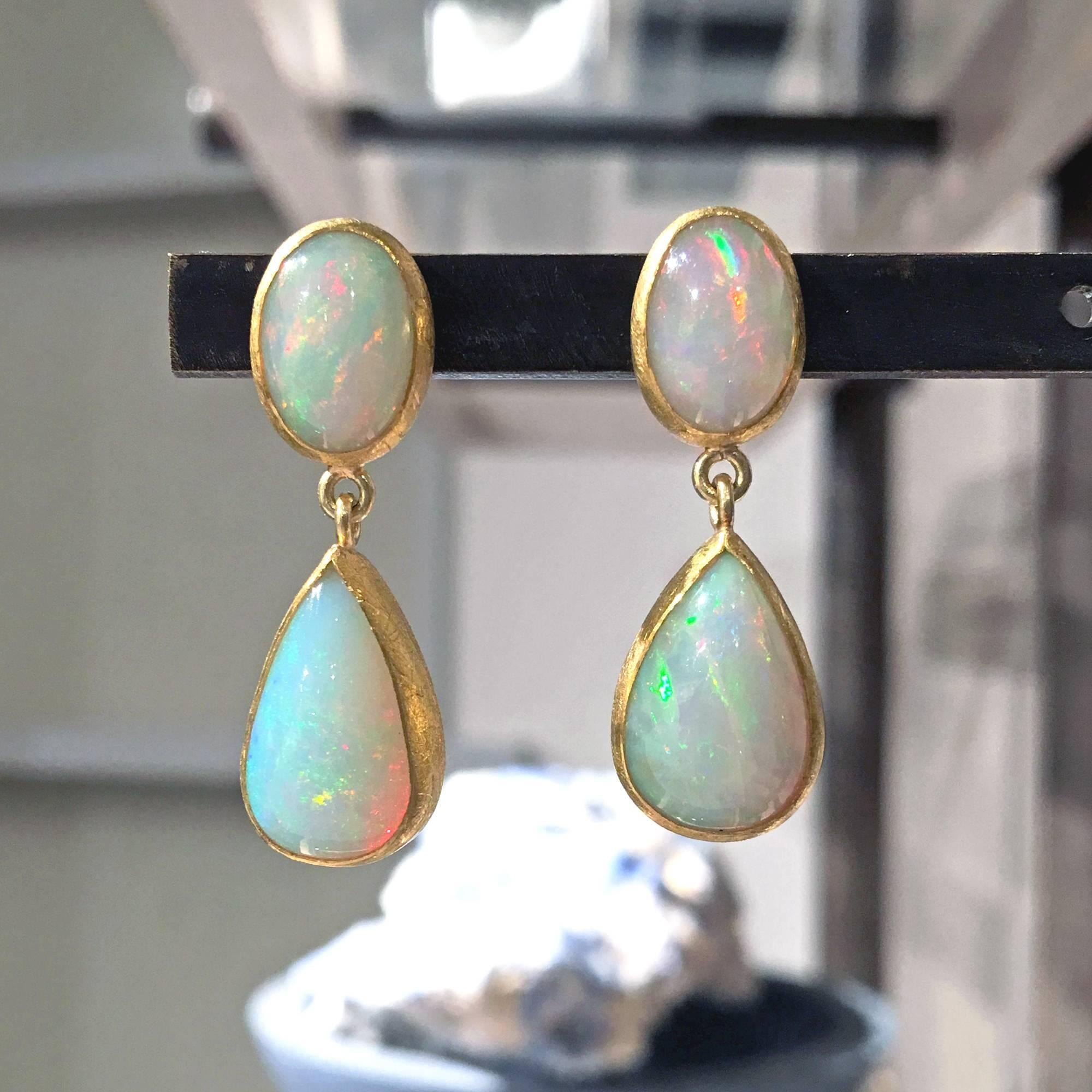 One of a Kind Double Drop Earrings handcrafted in matte-finished 22k yellow gold by Petra Class featuring a 7mm x 11mm cabochon-cut oval Ethiopian opal pair and a matched pair of approximately 9mm x 15mm cabochon-cut pear-shaped Ethiopian opals. All