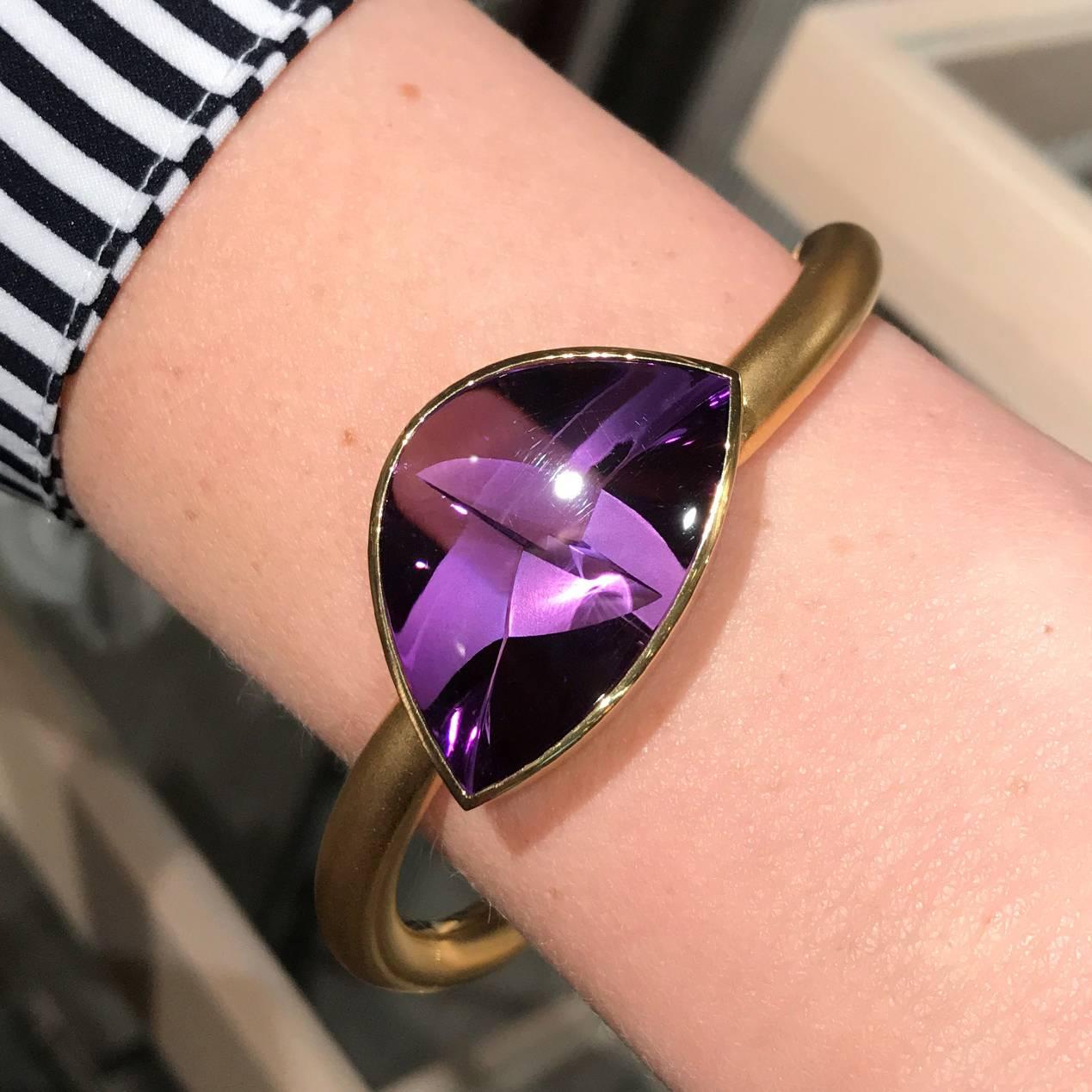 One of a Kind Bracelet handcrafted in Germany by internationally-renowned "Picasso of Gemstones" Atelier Munsteiner, featuring a spectacular 30.98 carat amethyst bezel-set in polished 18k yellow gold and attached to a satin-finished solid