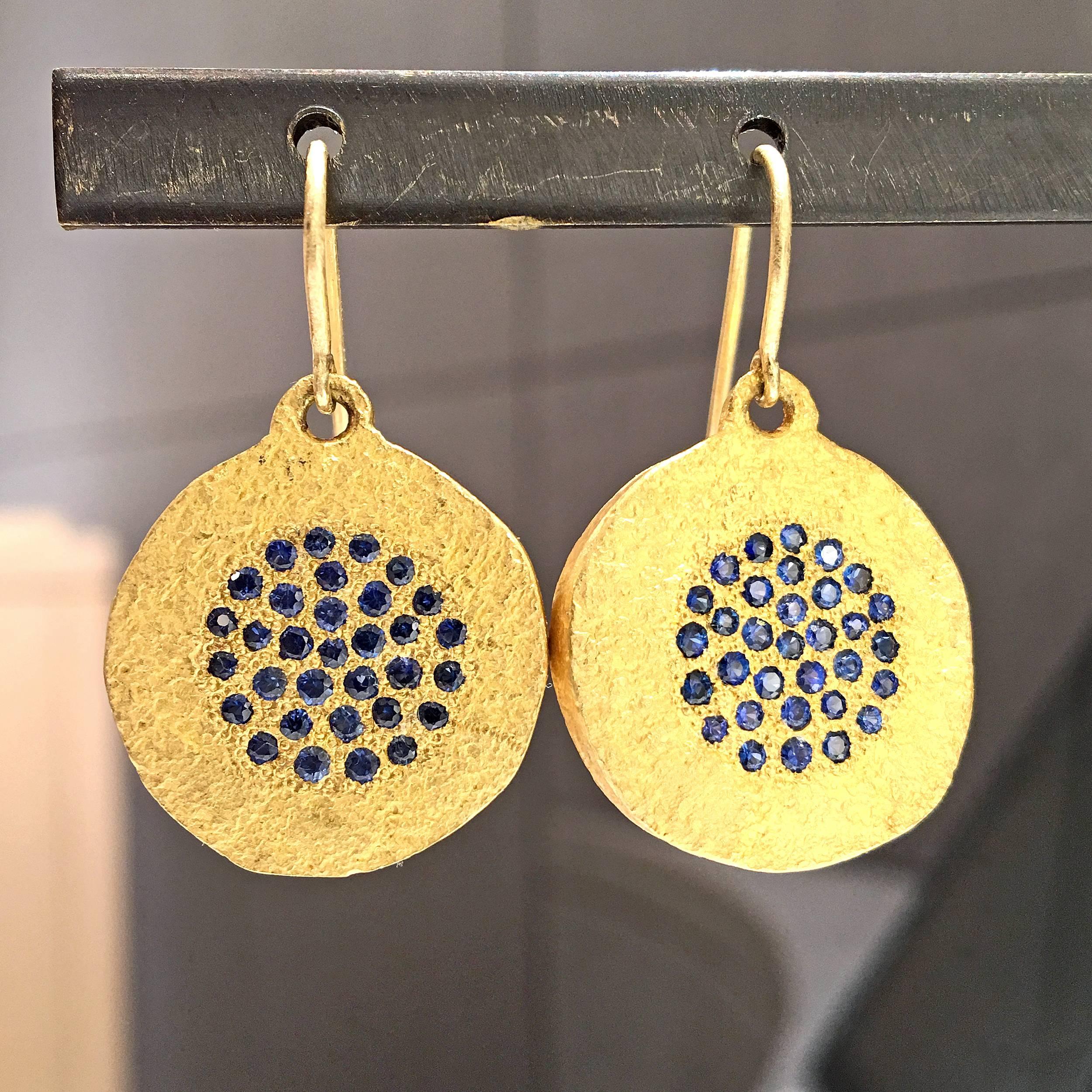 Coin Drop Earrings handcrafted by jewelry artist Devta Doolan in highly-textured 22k yellow gold featuring an array of exceptional-quality shimmering blue sapphires and dangling from handmade gold ear wires. 

Stamped 22k / 2015 with the artist's