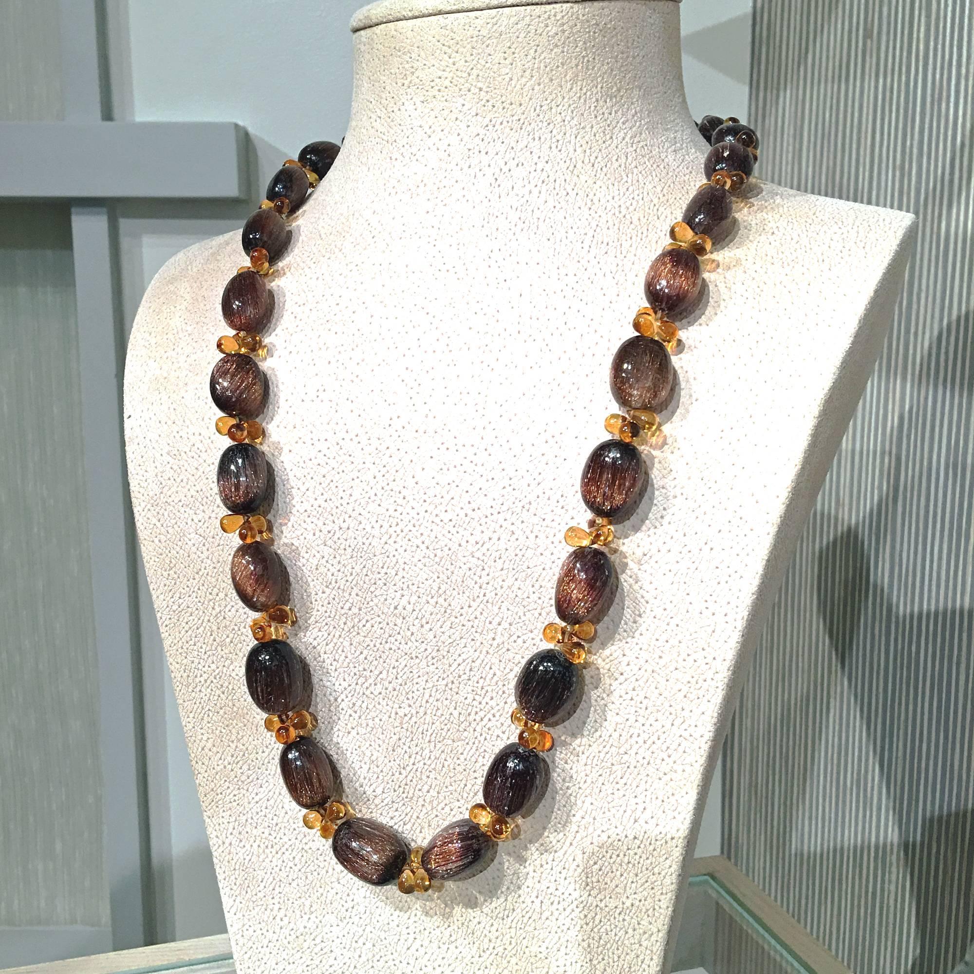 One of a Kind Necklace handcrafted by jewelry designer Joseph Murray featuring an array of rutilated quartz oval beads with a vibrant sheen and separated by triple clusters of smooth citrine briolettes on an 18k yellow gold toggle clasp. Stamped and