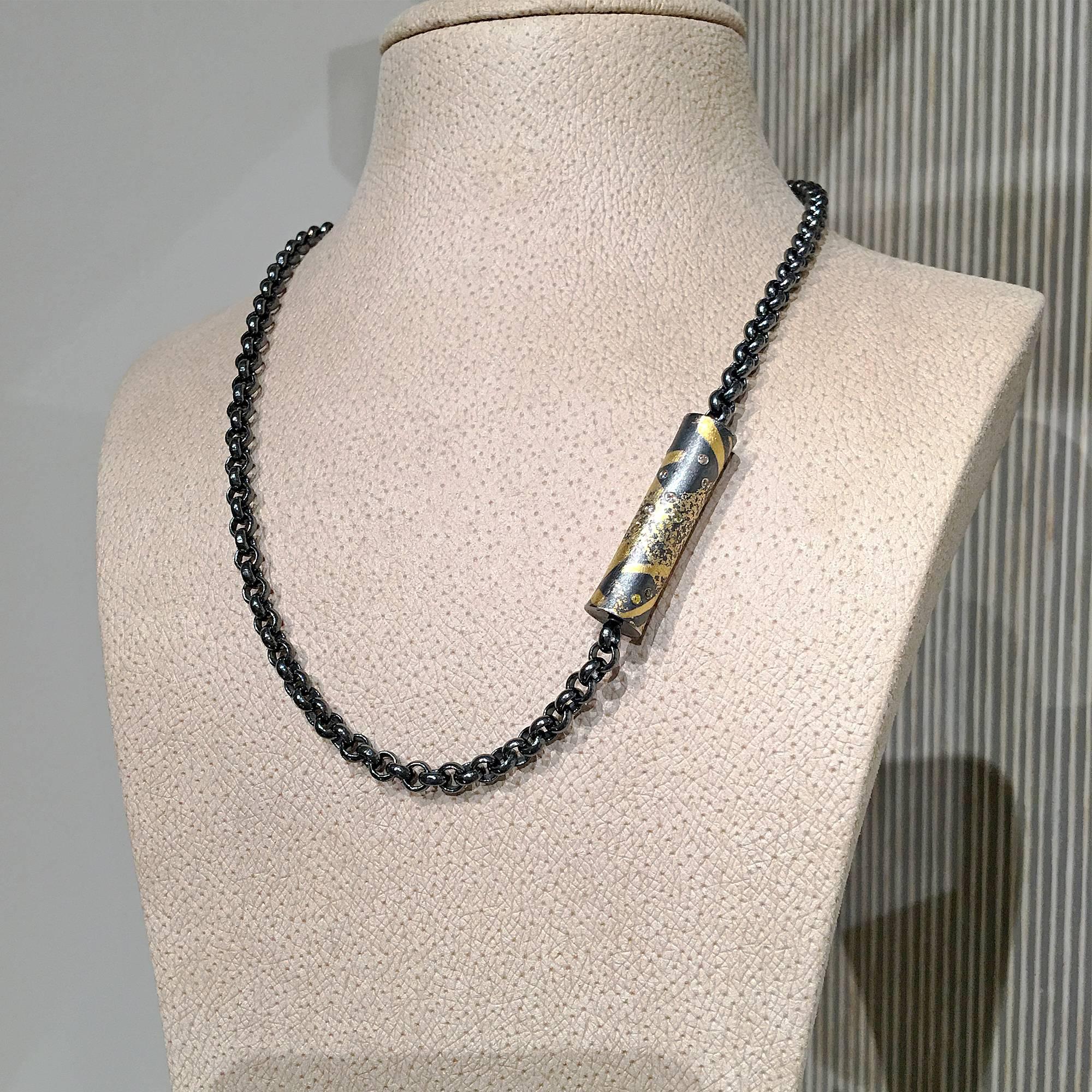 Barrel Necklace handcrafted by renowned jewelry artist Atelier Zobel (Peter Schmid) featuring a 24k gold and oxidized sterling silver concave cylindrical clasp embedded with 0.21 total carats of natural fancy color diamonds and attached on both ends
