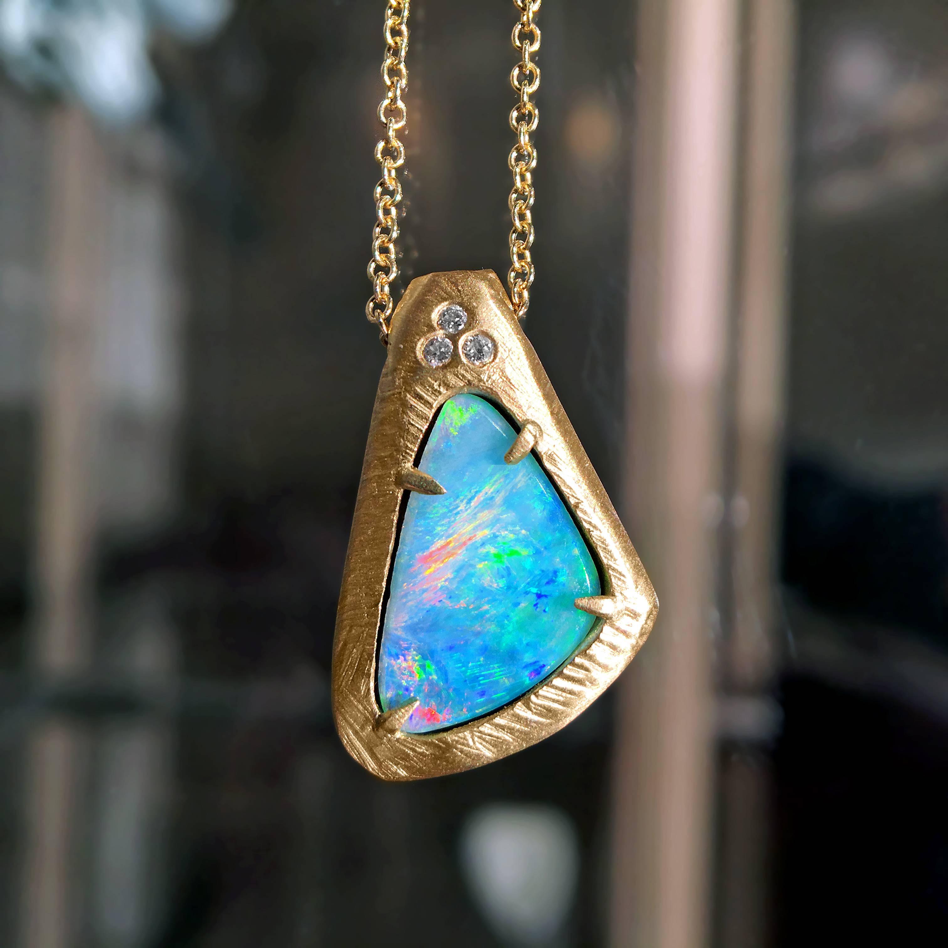 One of a Kind Necklace handcrafted in New York in textured and matte-finished 18k yellow gold featuring a fiery Australian boulder opal set by four claws and accented with three round brilliant-cut white diamonds. On a 16.5 inch 18k yellow gold